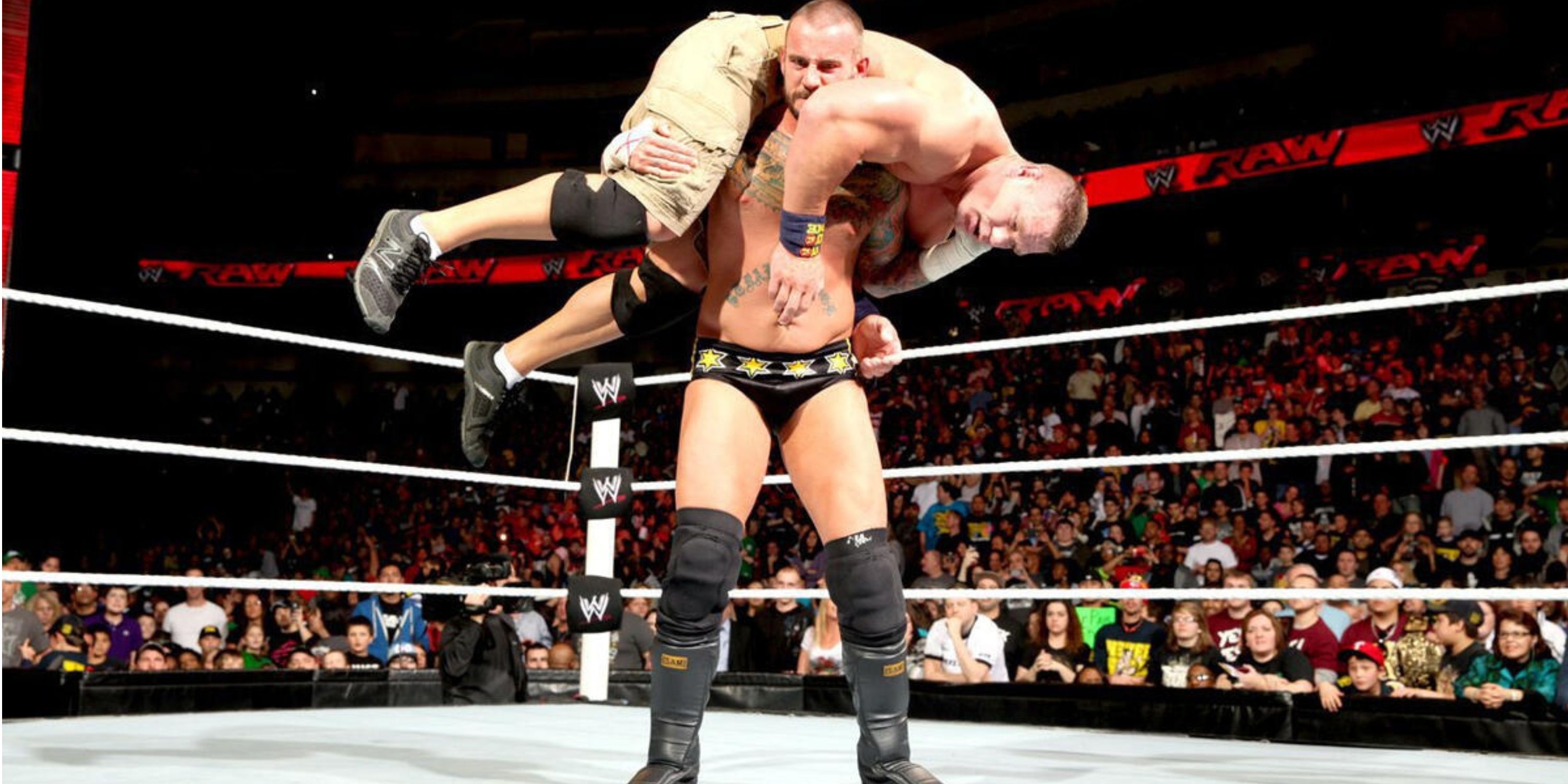 CM Punk with John Cena on his shoulders on WWE RAW in February 2013