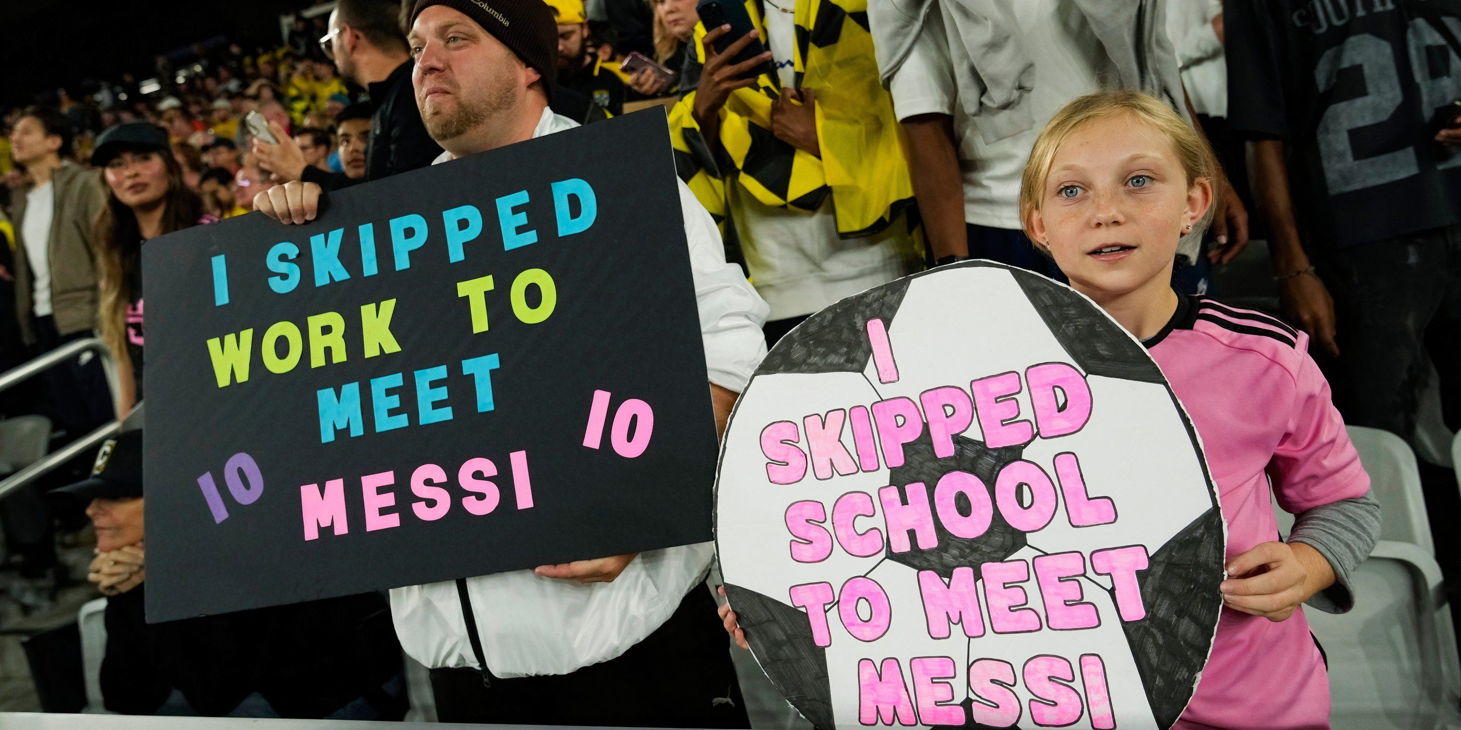 Fans hold up posters about Lionel Messi