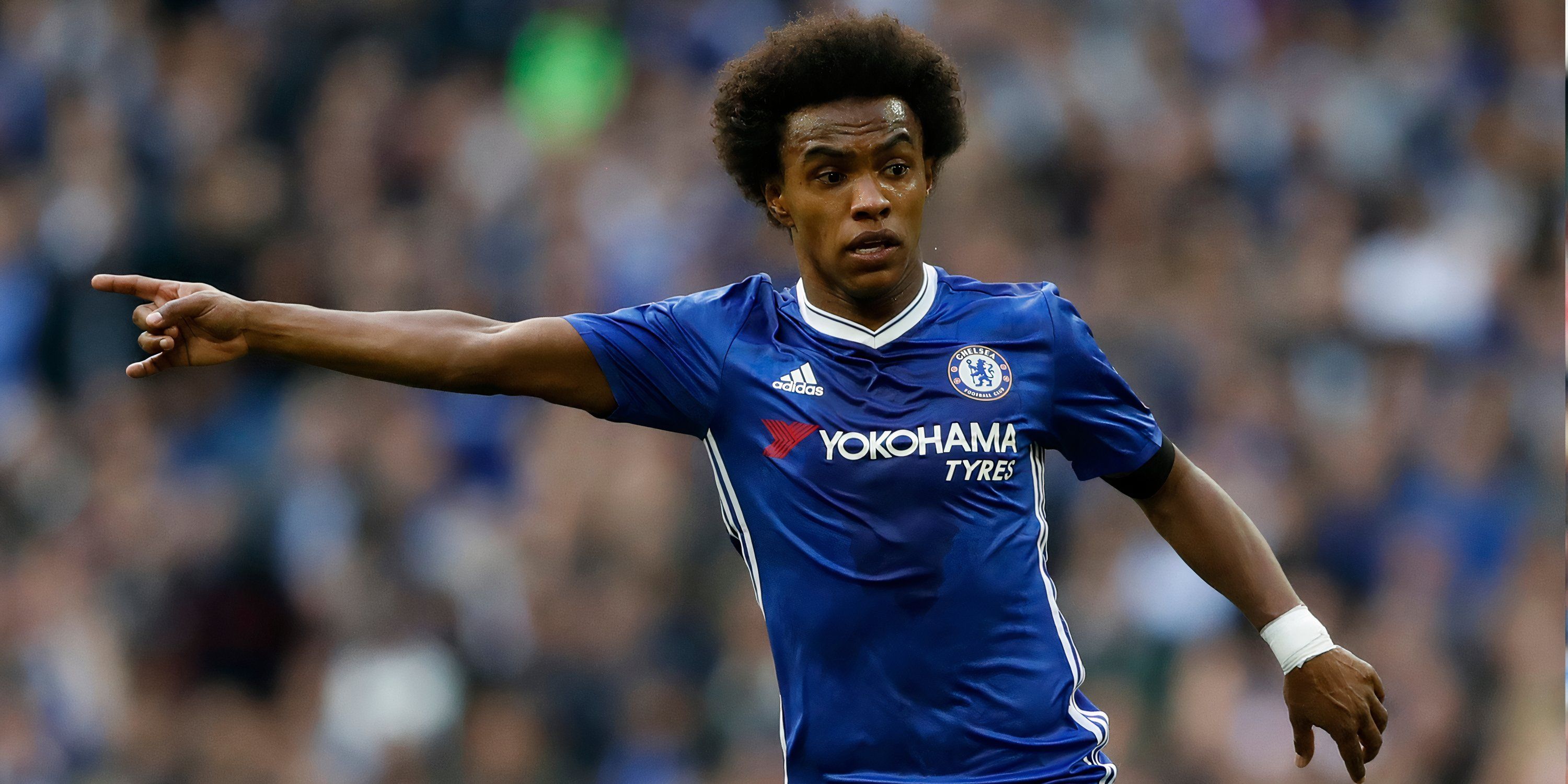 Willian points at a team-mate during his time at Chelsea.