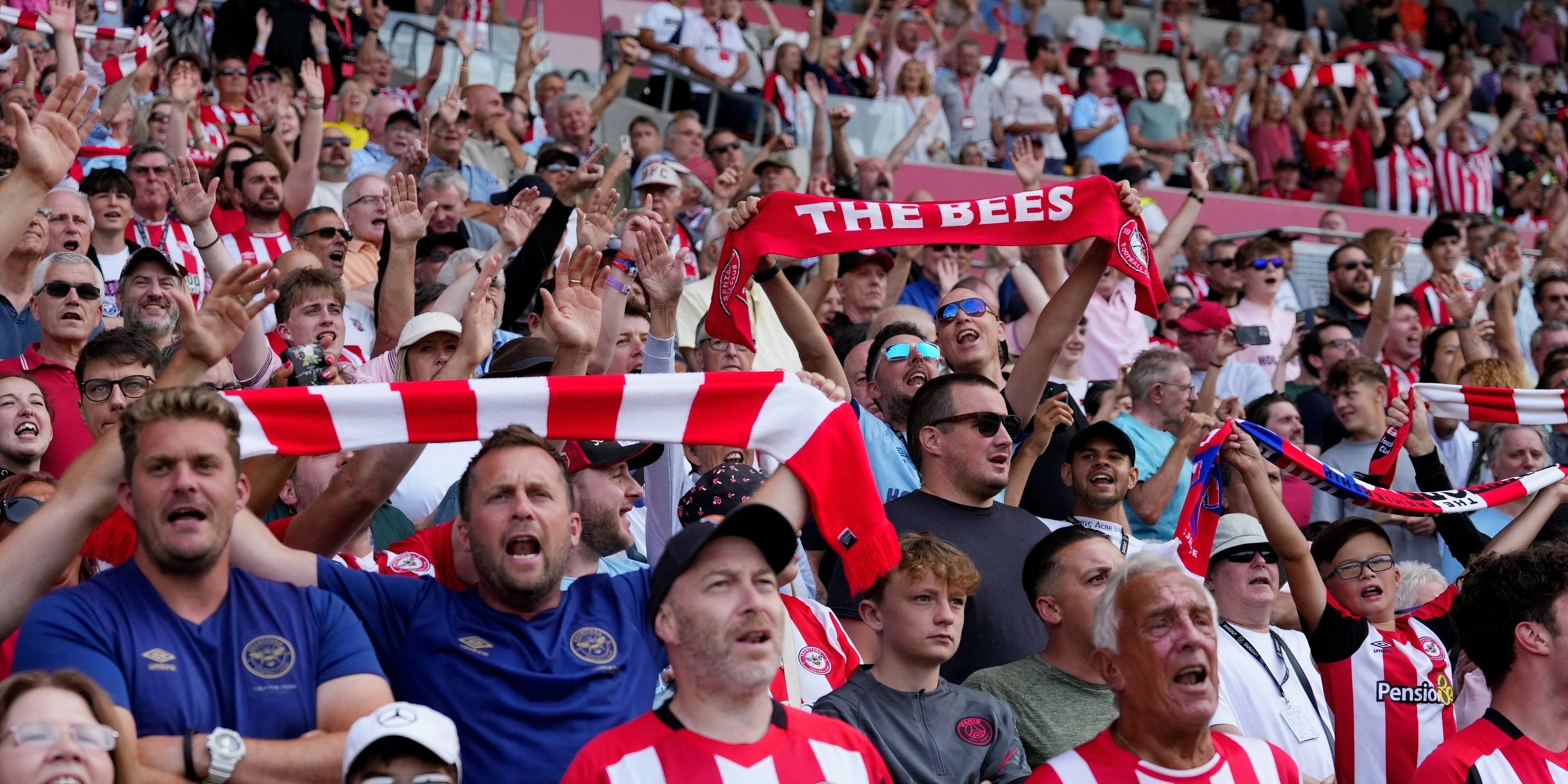 Brentford fans singing during a game.