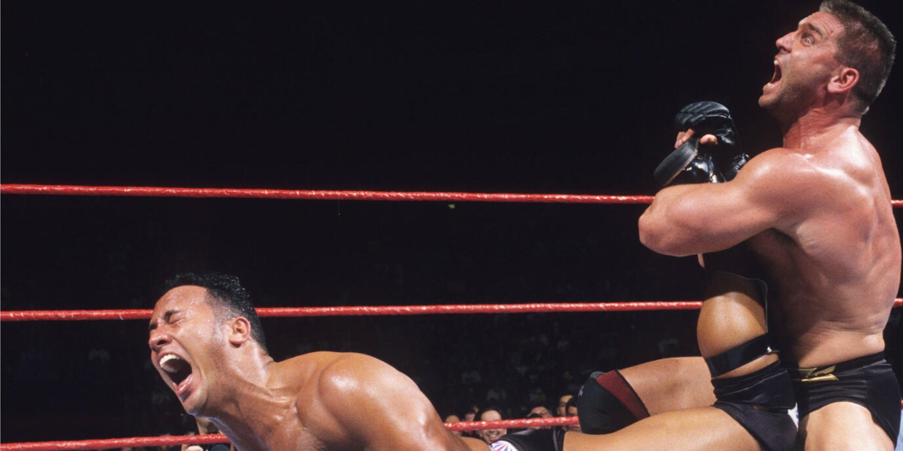 Ken Shamrock applies the Ankle Lock to The Rock