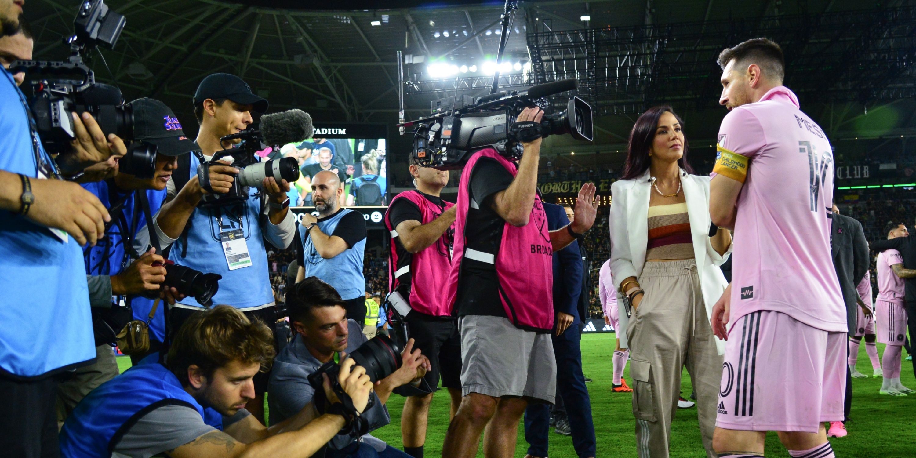 Lionel Messi being surrounded by the media