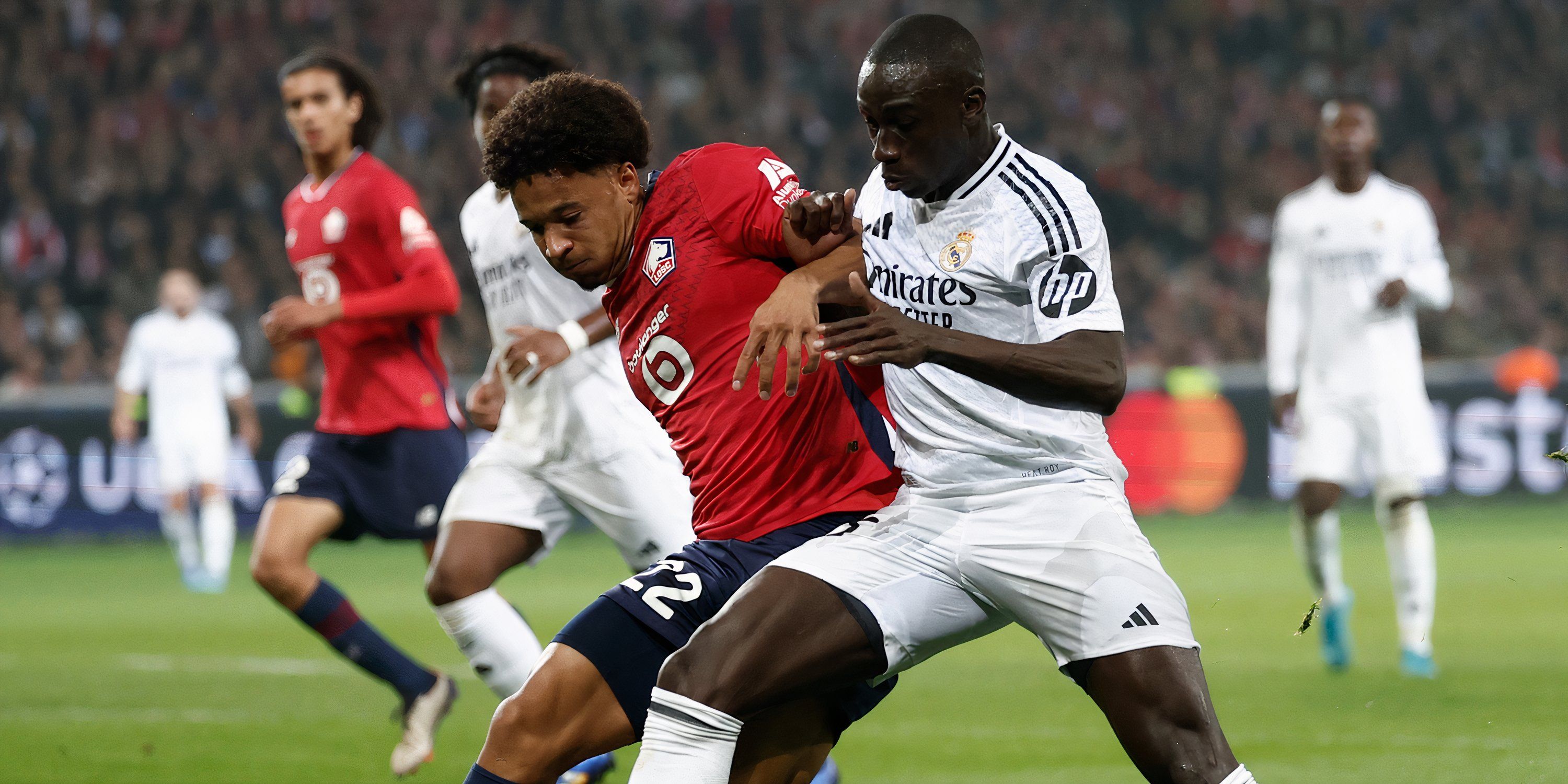 Lille right-back Tiago Santos battling with Real Madrid left-back Ferland Mendy for possession