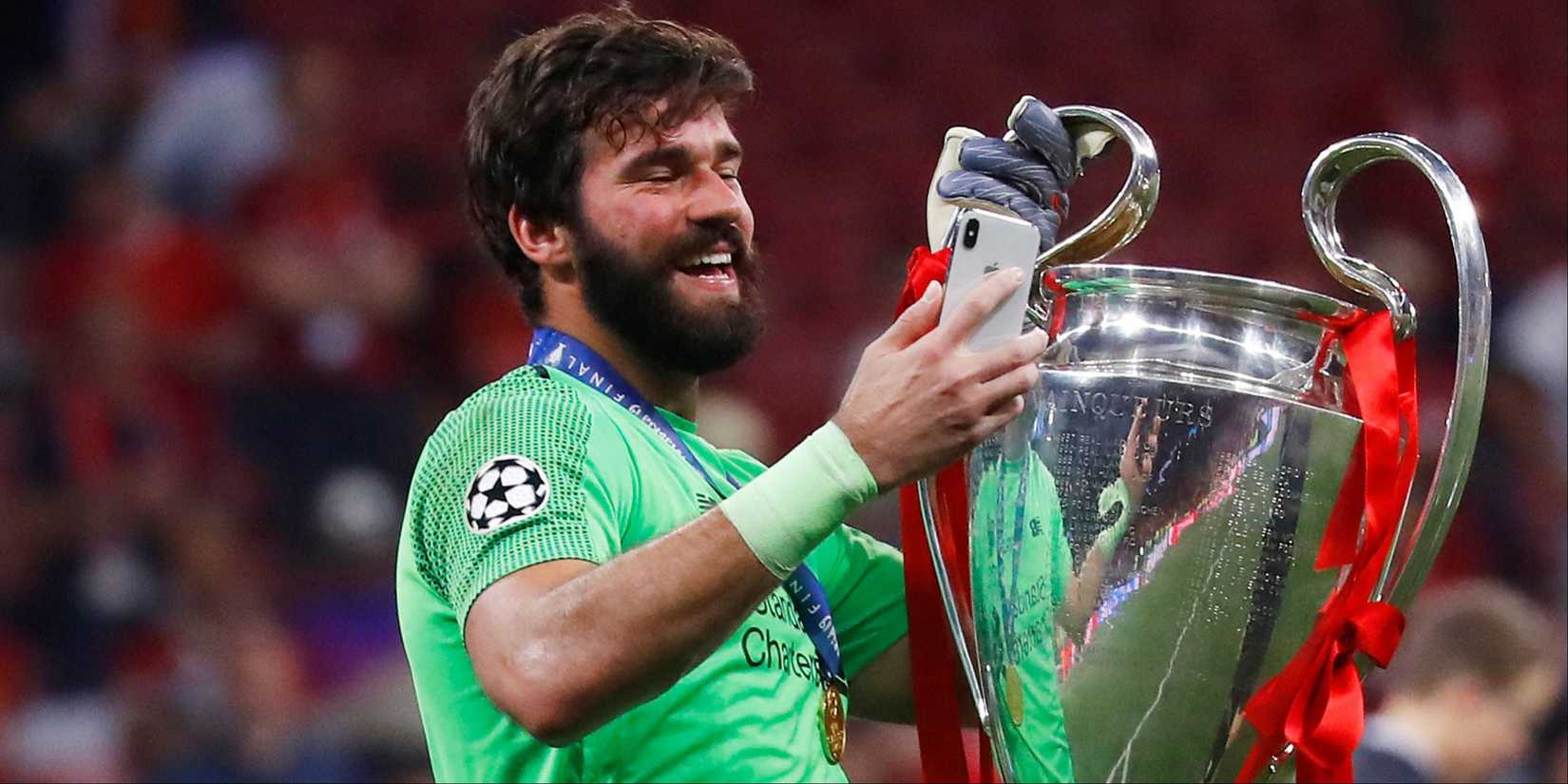 Alisson with the Champions League trophy