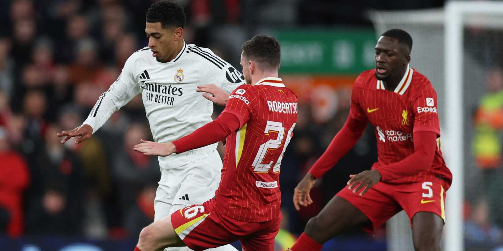 Real Madrid's Jude Bellingham in action with Liverpool's Andrew Robertson and Ibrahima Konate