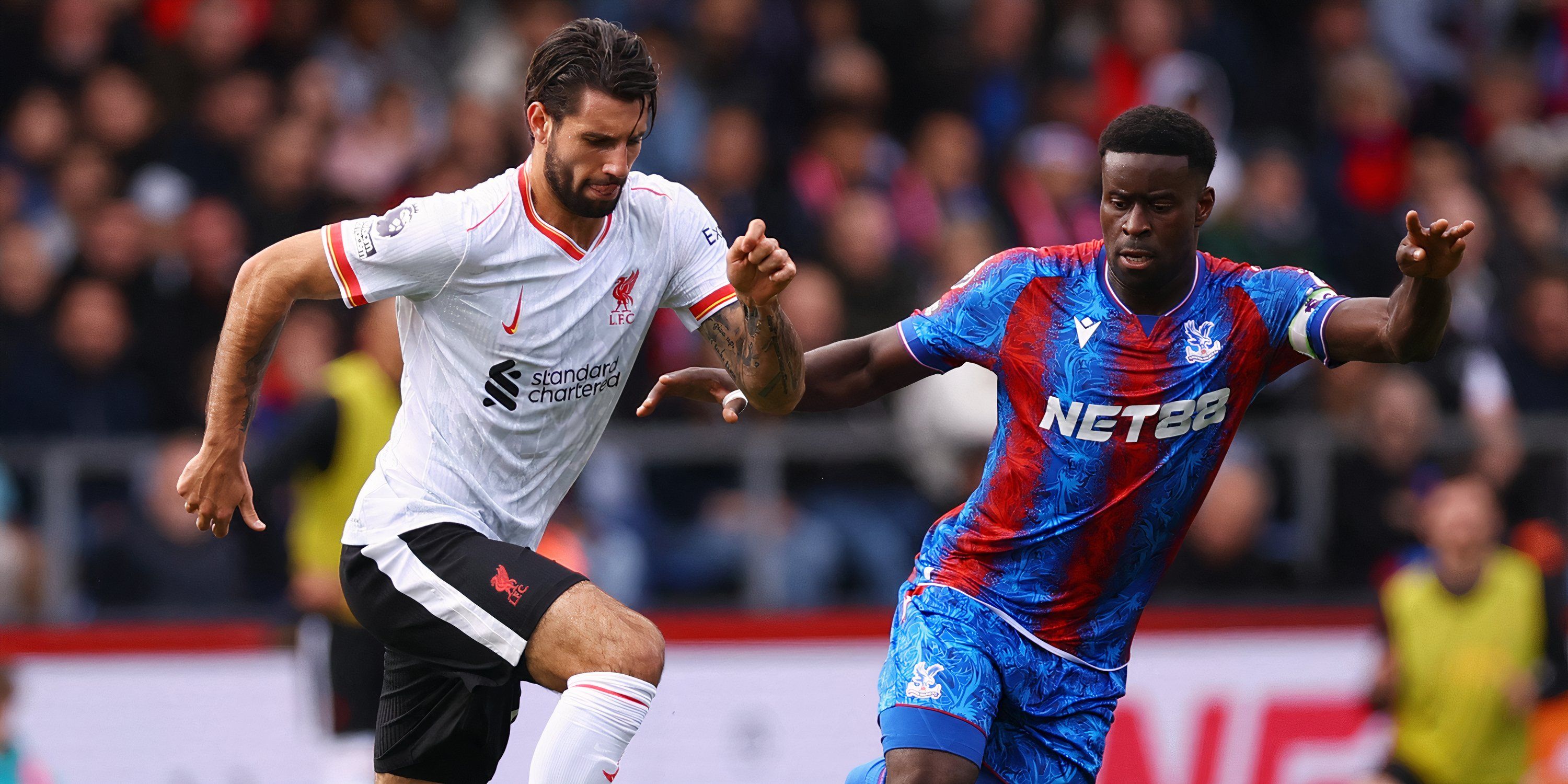 Liverpool midfielder Dominik Szoboszlai and Crystal Palace defender Marc Guehi battling for possession