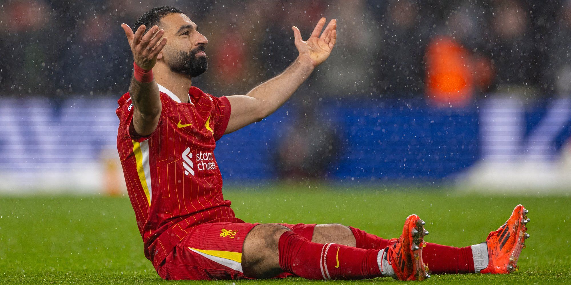 Liverpool striker Mo Salah sitting on the pitch