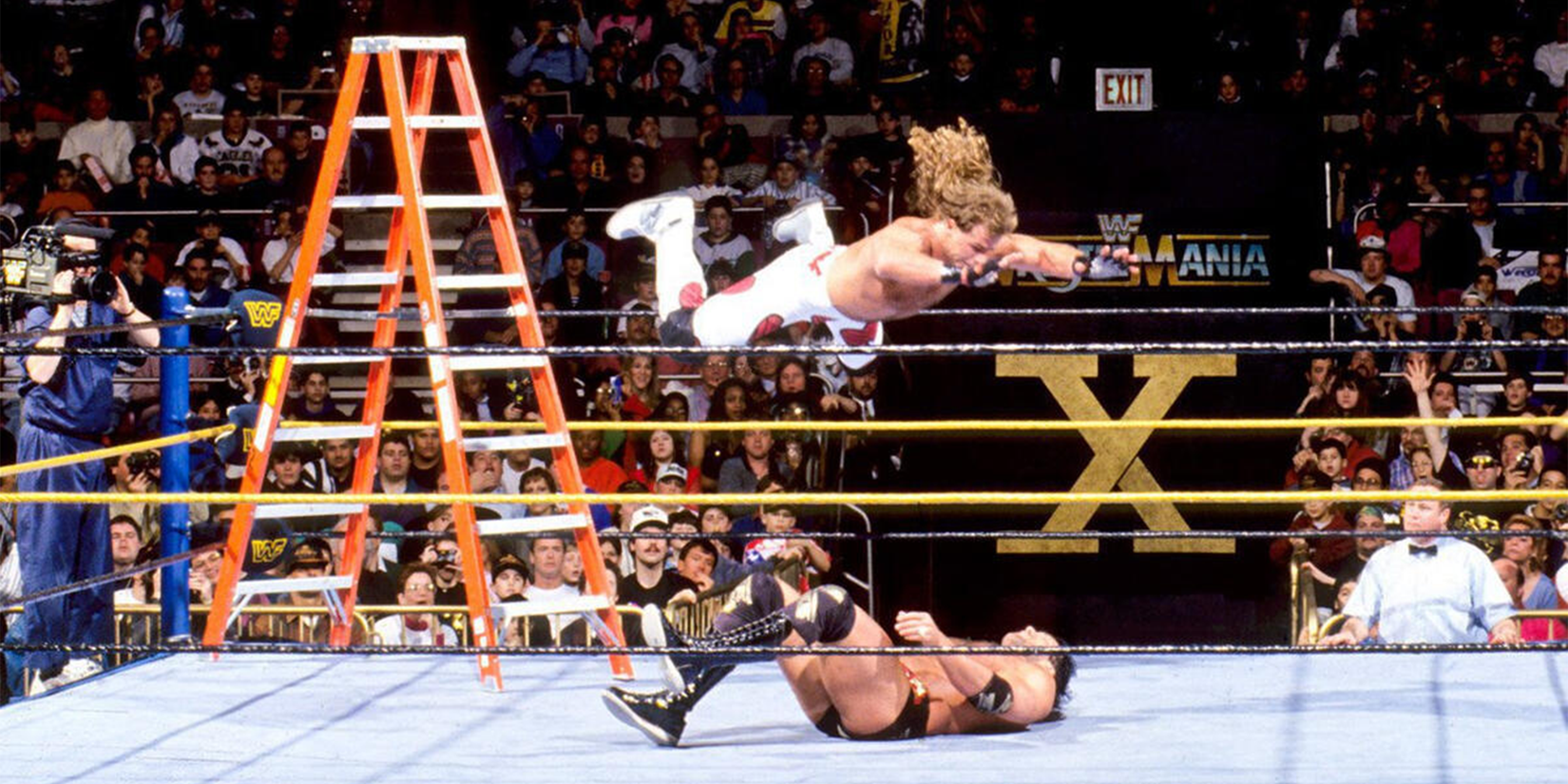 Shawn Michaels soars for an iconic splash on Razor Ramon at WrestleMania 10