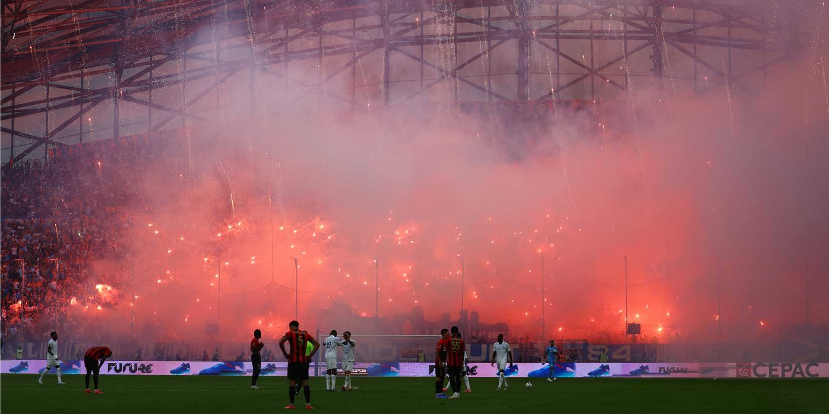 General view as fans inside the stadium let off flares during the match