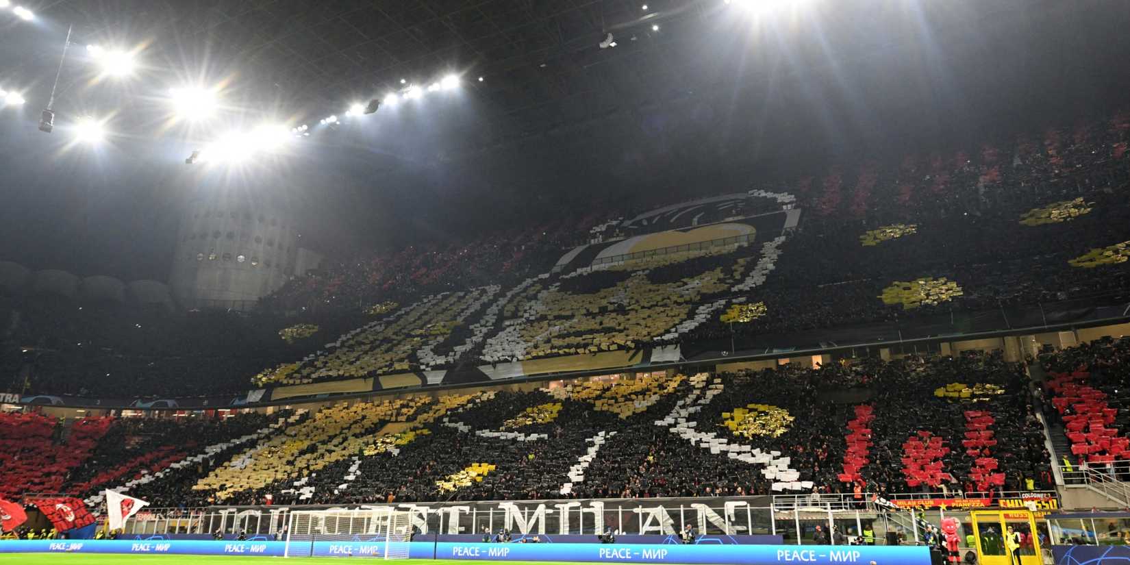 General view as the AC Milan fans display banners inside the stadium before the match