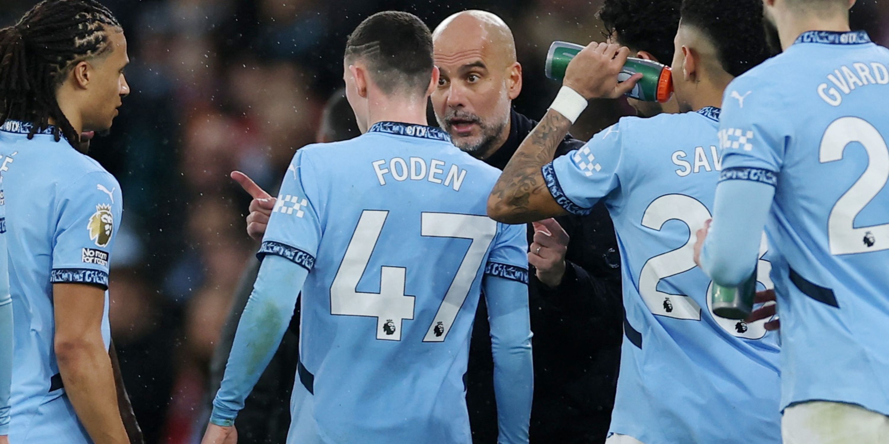 Pep Guardiola in conversation with Manchester City players
