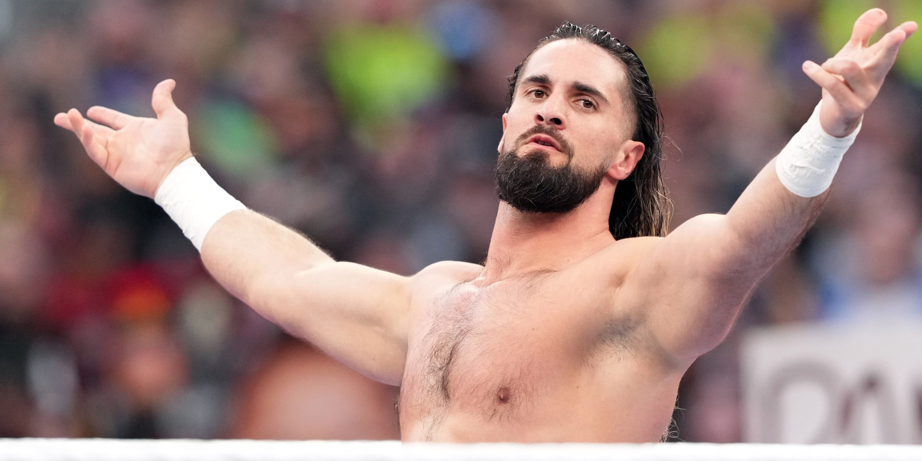 WWE's Seth Rollins with his arms open.