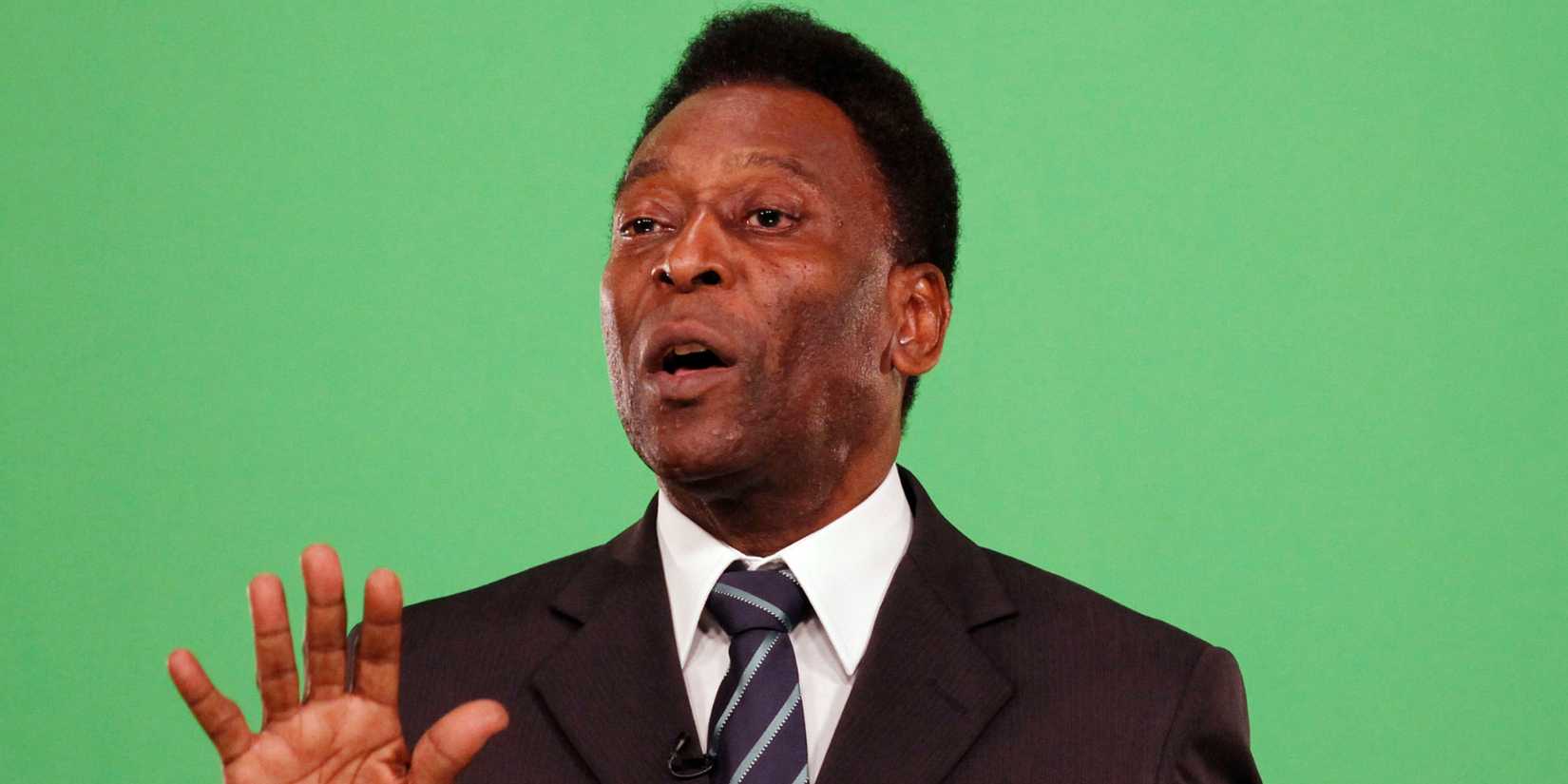 Brazilian former soccer star Edson Arantes Do Nascimento, better known as Pele, gestures as he holds the FIFA World Cup soccer ball