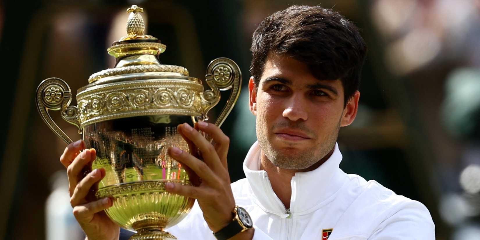 Carlos Alcaraz with Wimbledon trophy