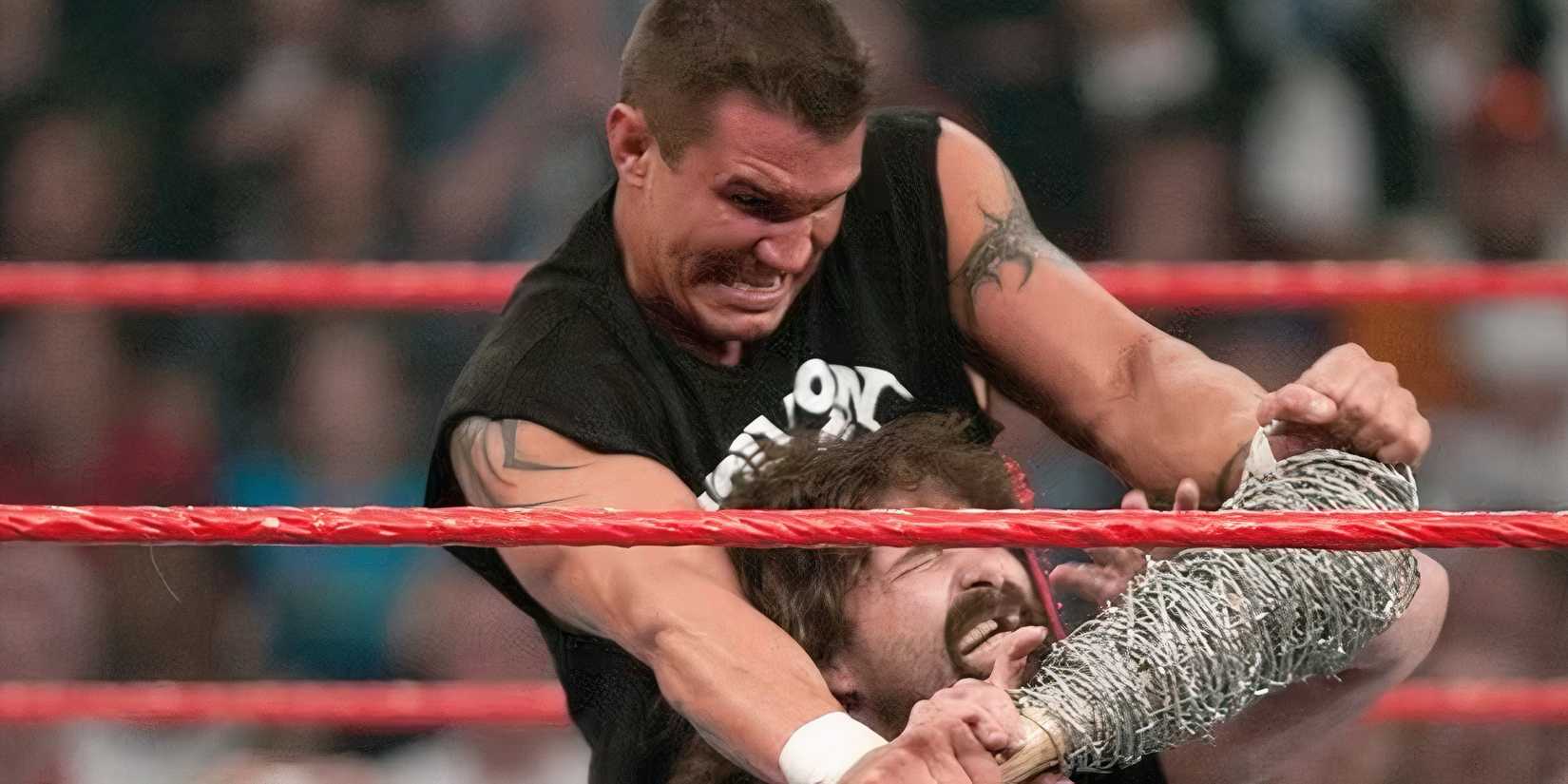 Randy Orton chokes Mick Foley