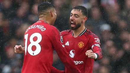 Bruno Fernandes and Casemiro embracing after Manchester United score against Chelsea