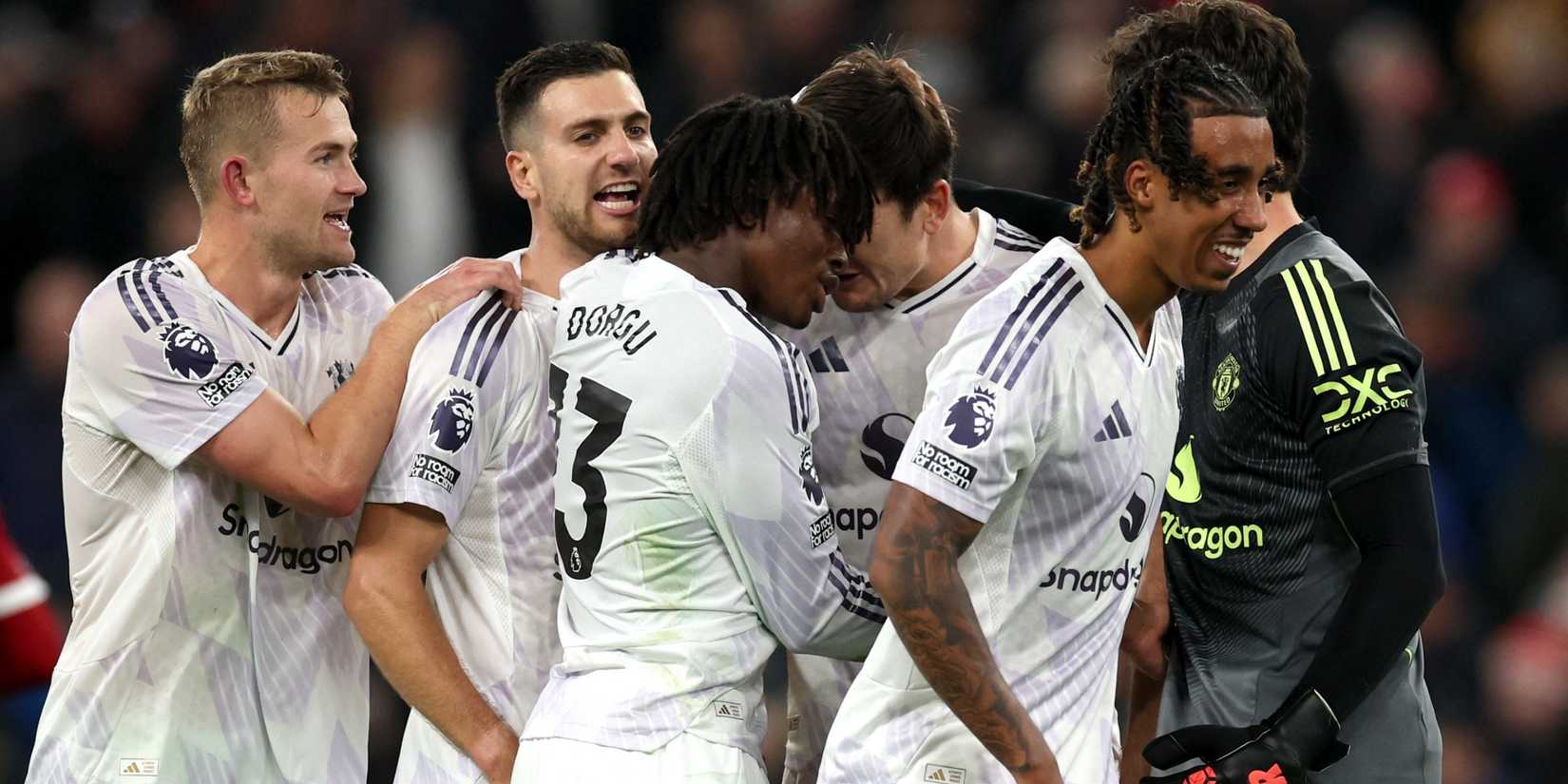 Manchester United players celebrating after defeating Liverpool