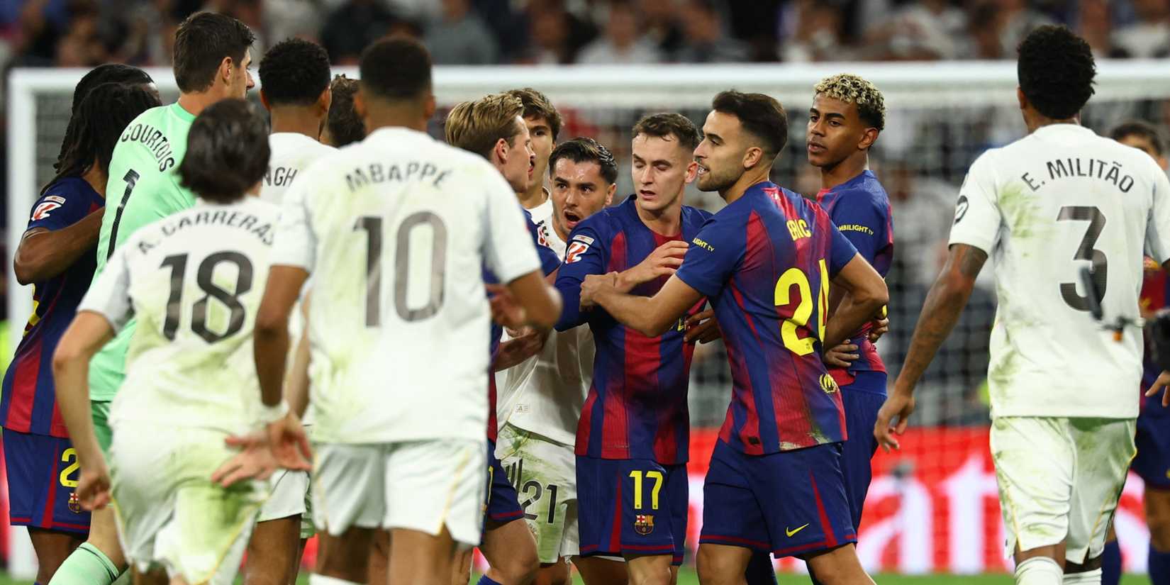 Real Madrid and FC Barcelona players clash after the match