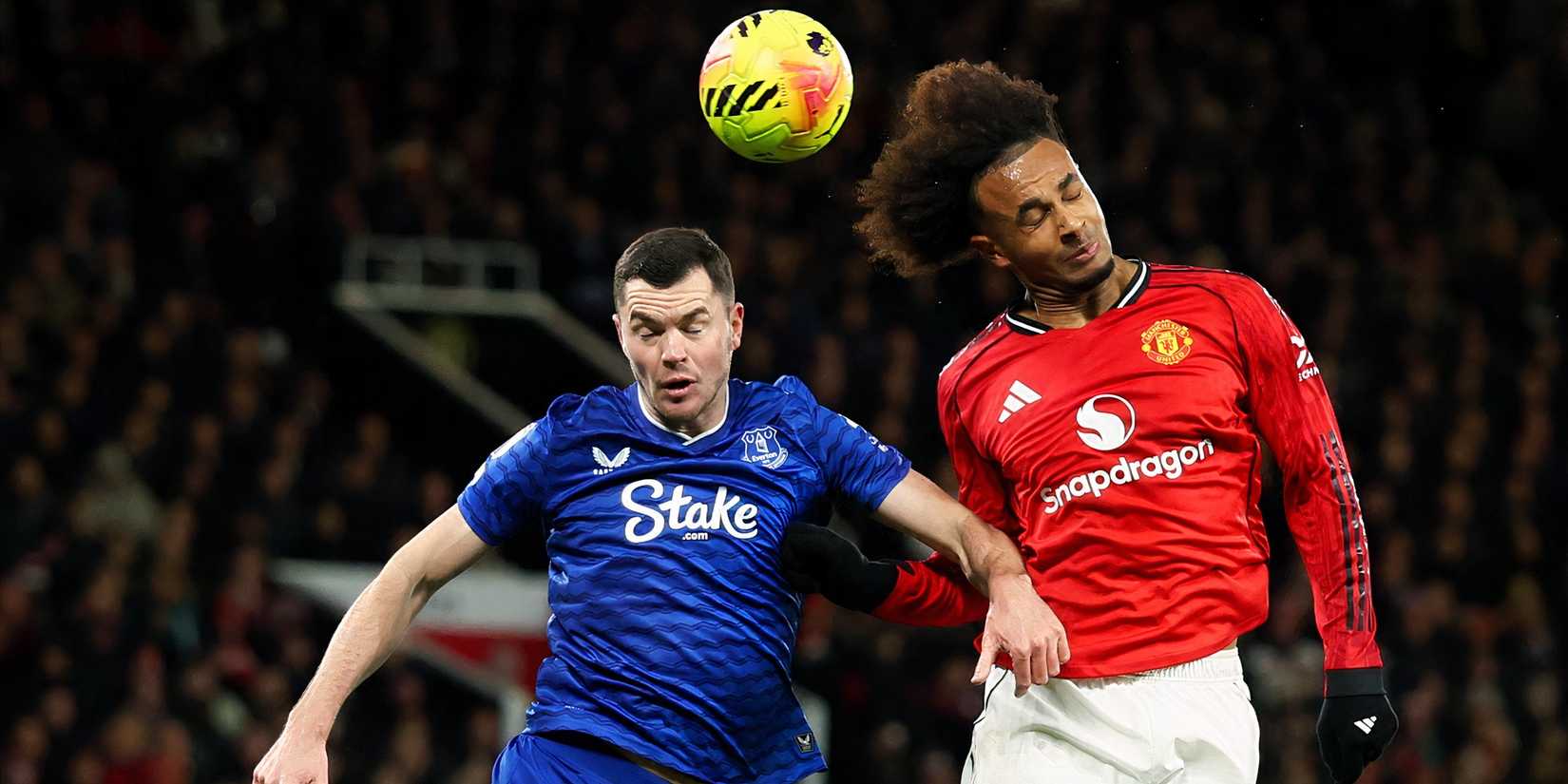 Michael Keane heads a ball
