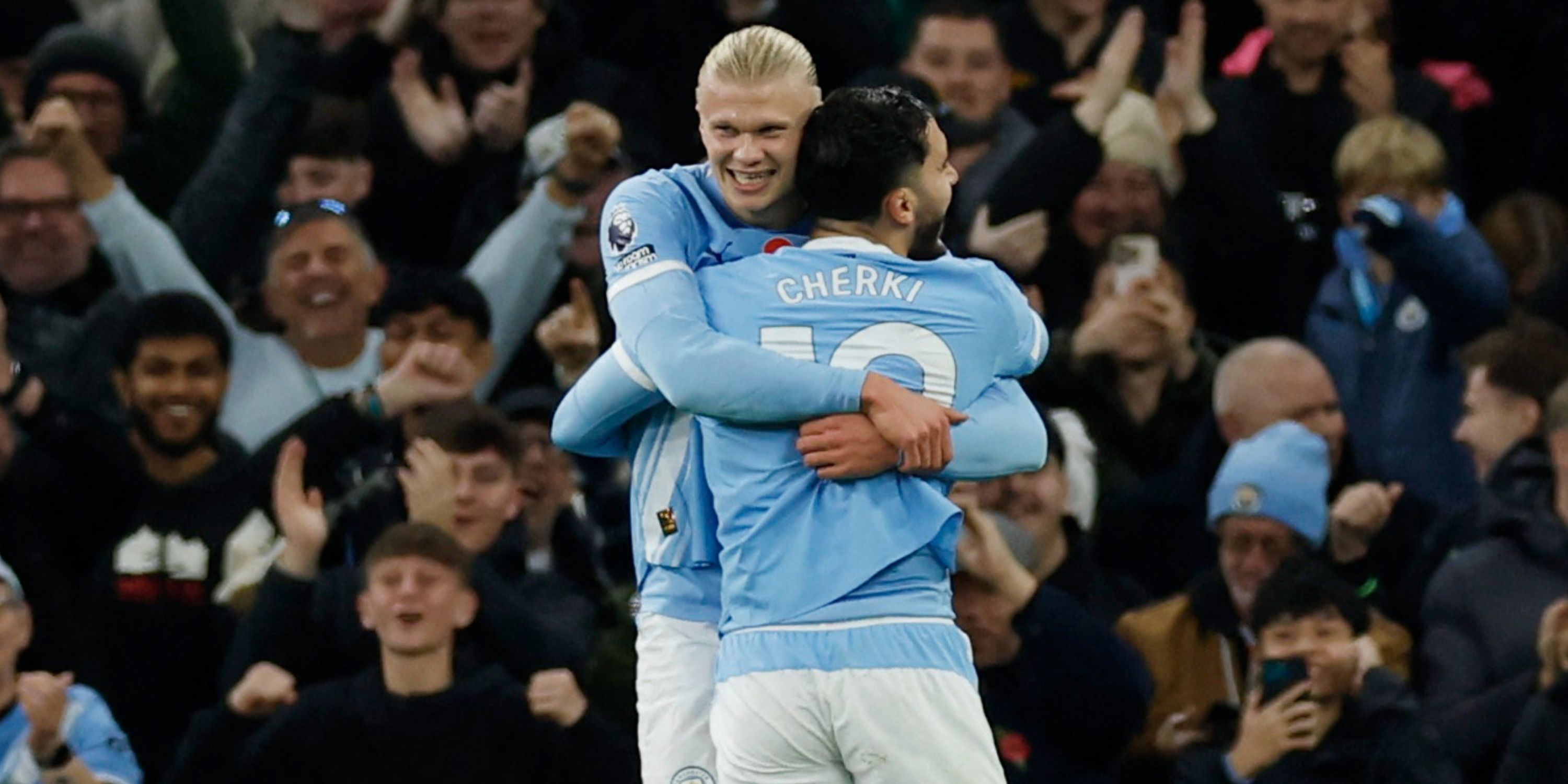 Erling Haaland celebrates scoring with teammate Rayan Cherki during Manchester City vs Bournemouth.
