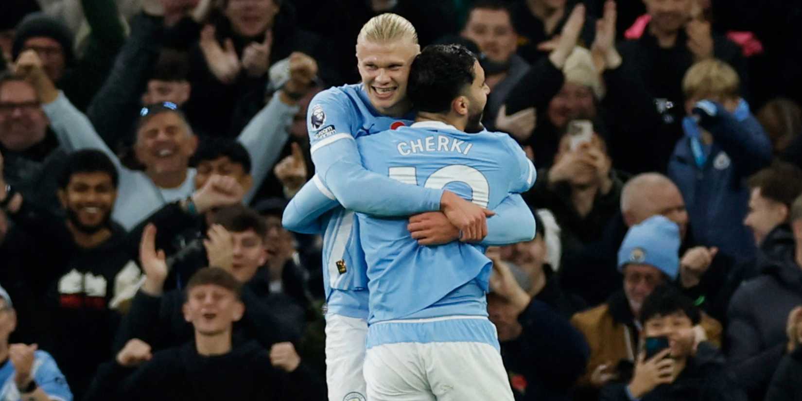 Erling Haaland celebrates scoring with teammate Rayan Cherki during Manchester City vs Bournemouth.