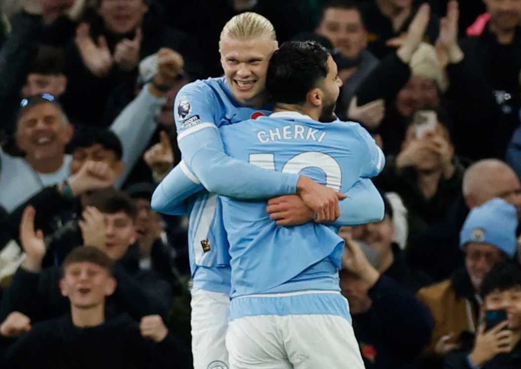 Erling Haaland celebrates scoring with teammate Rayan Cherki during Manchester City vs Bournemouth.