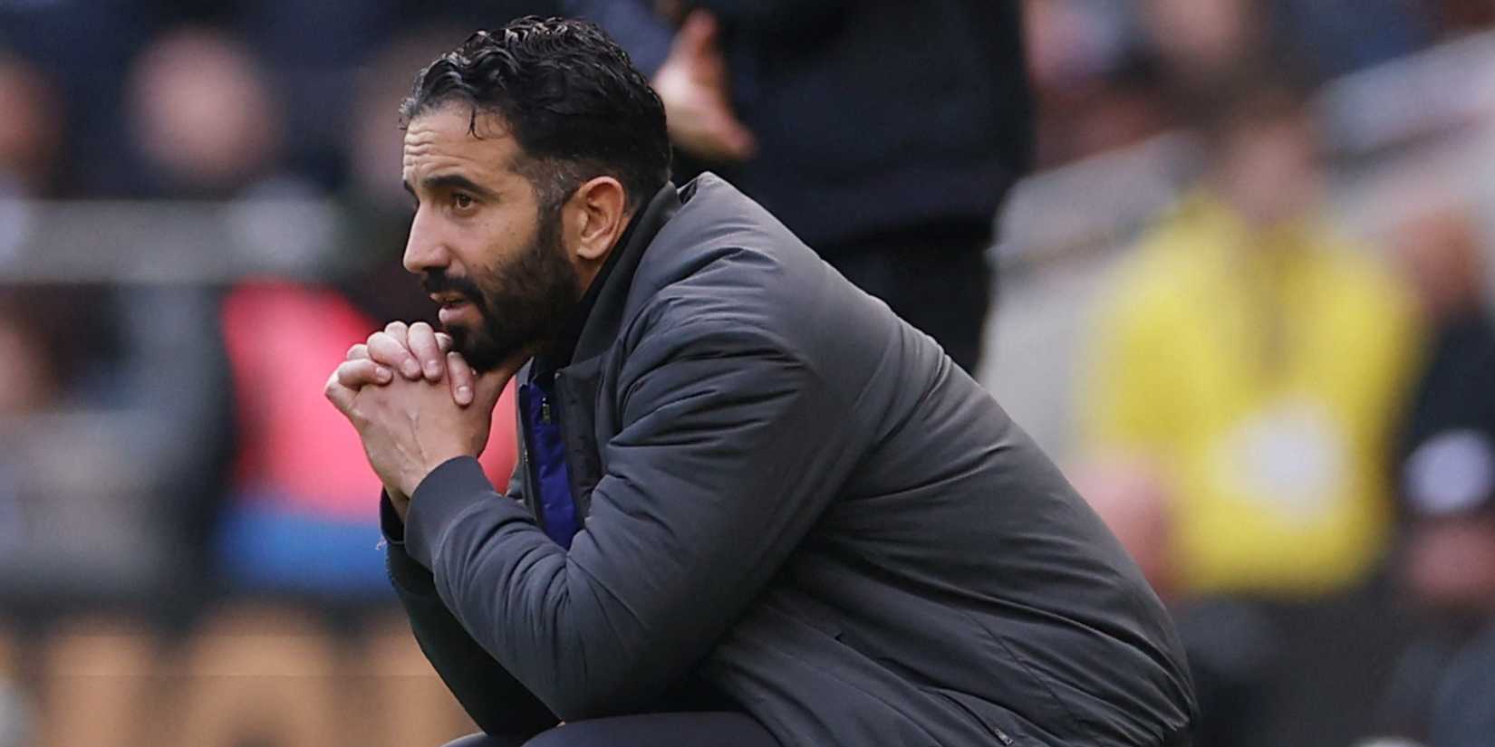 Manchester United manager Ruben Amorim crouching.