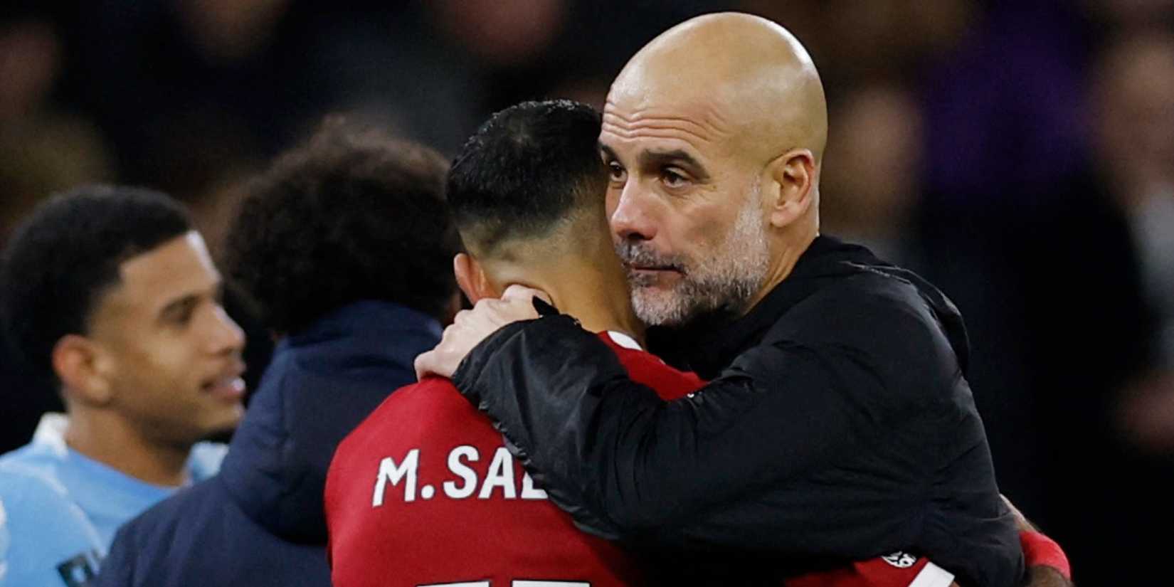Manchester City manager Pep Guardiola embracing Liverpool's Mohamed Salah after their match.