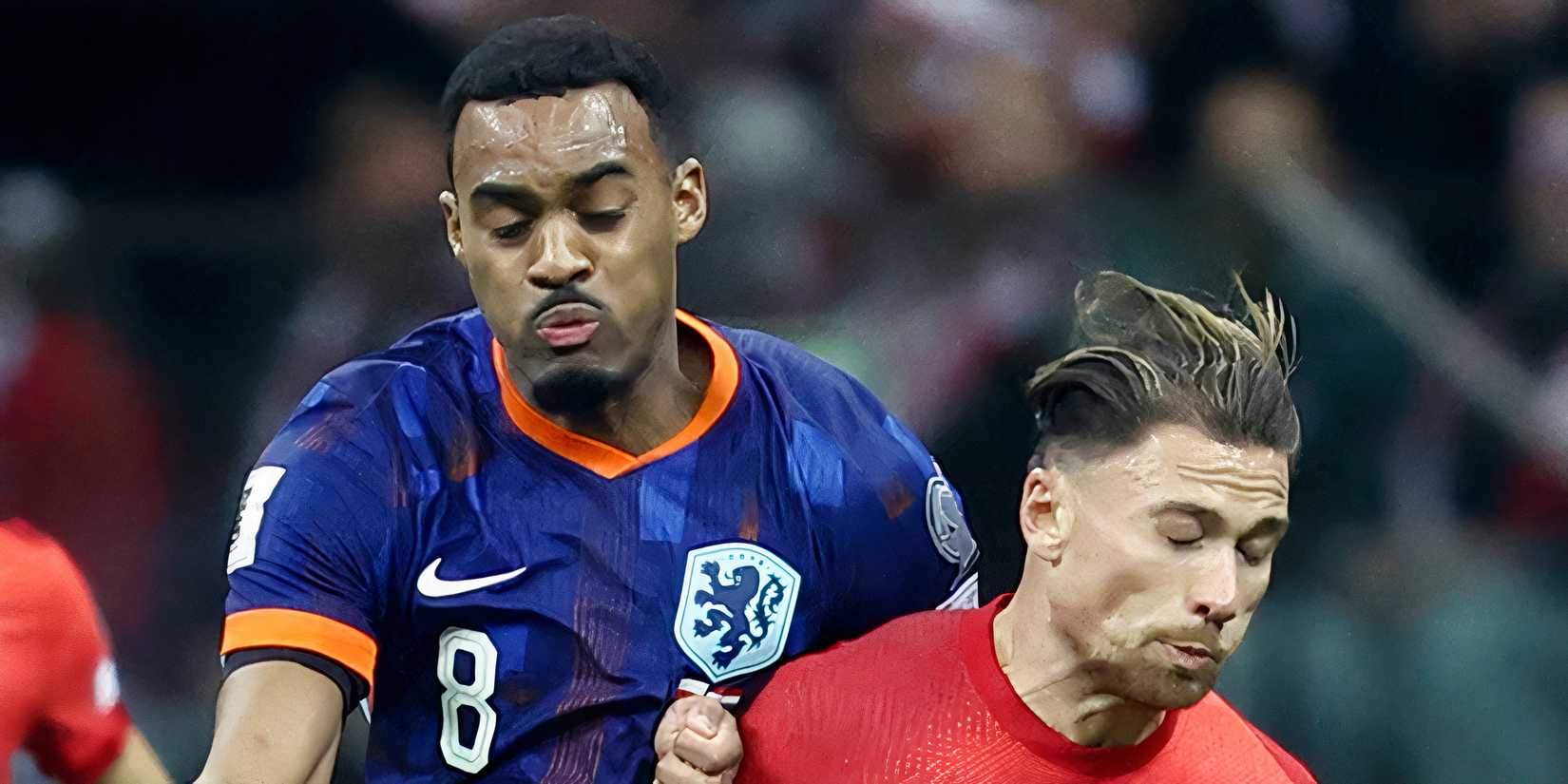 Netherlands' Ryan Gravenberch in action with Poland's Matty Cash