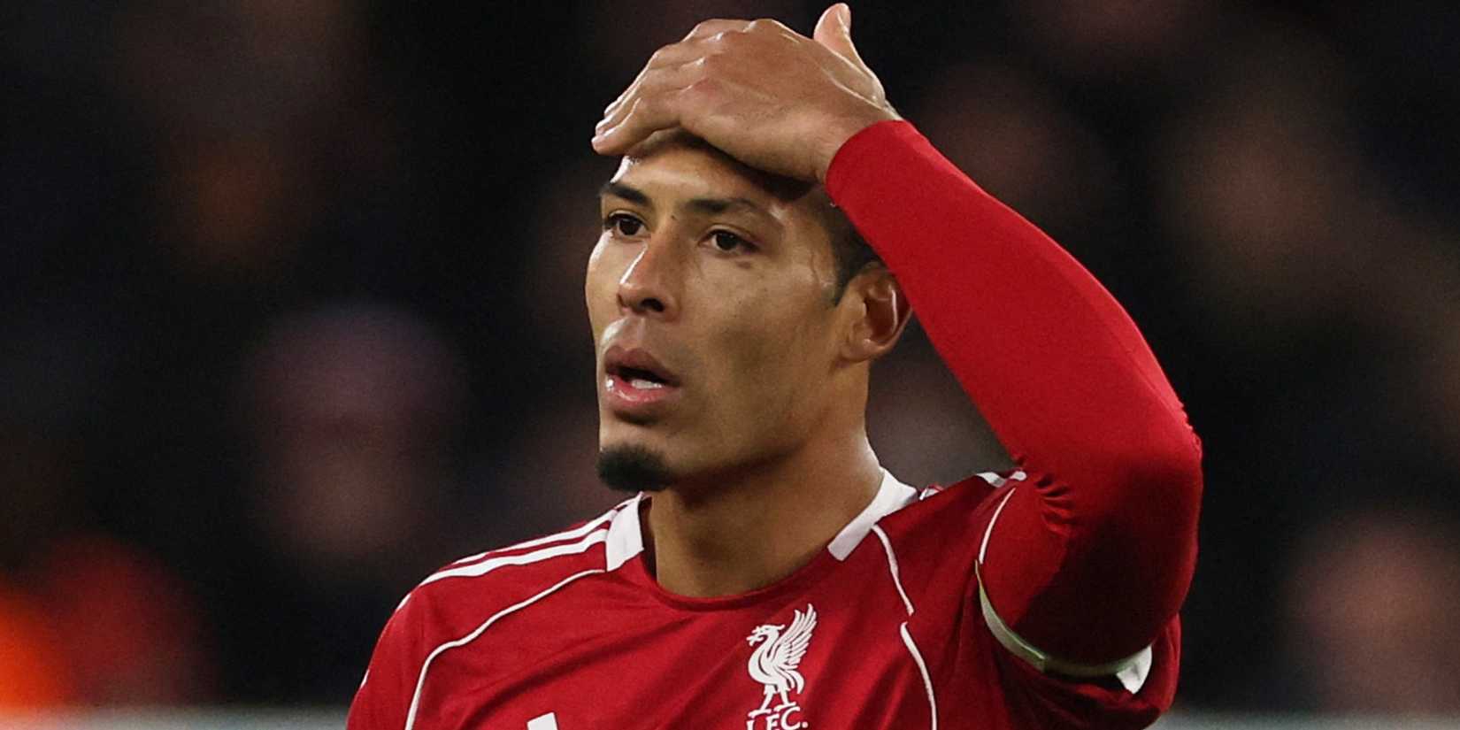 Liverpool's Virgil van Dijk puts his hand on his head.