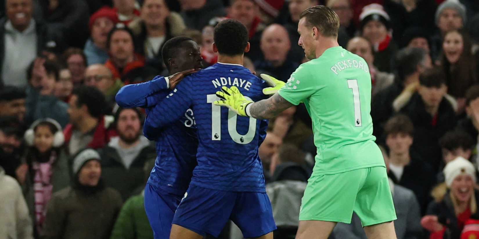 Everton's Idrissa Gueye is held back by teammates Everton's Iliman Ndiaye and Jordan Pickford
