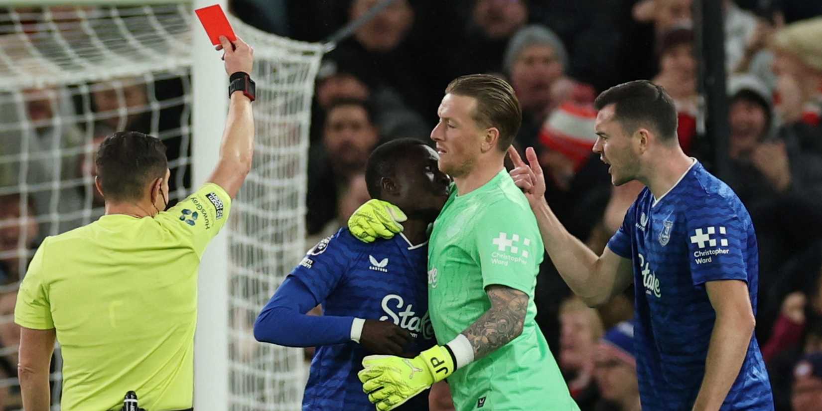Everton's Idrissa Gueye is held back by Everton's Jordan Pickford as he clashes with teammate Michael Keane 