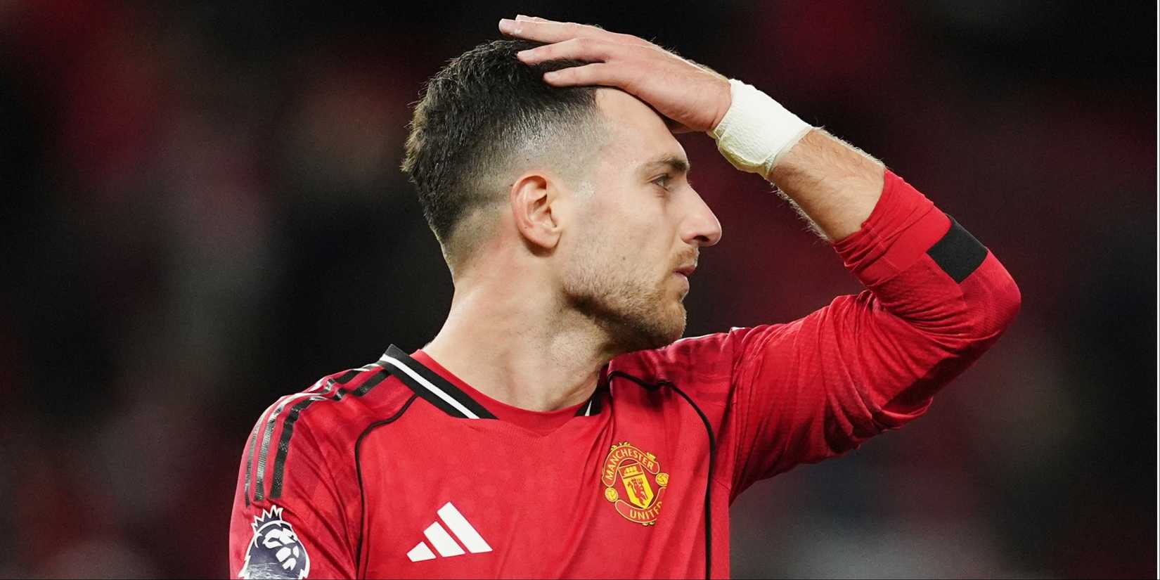 Manchester United's Diogo Dalot rubs his head.