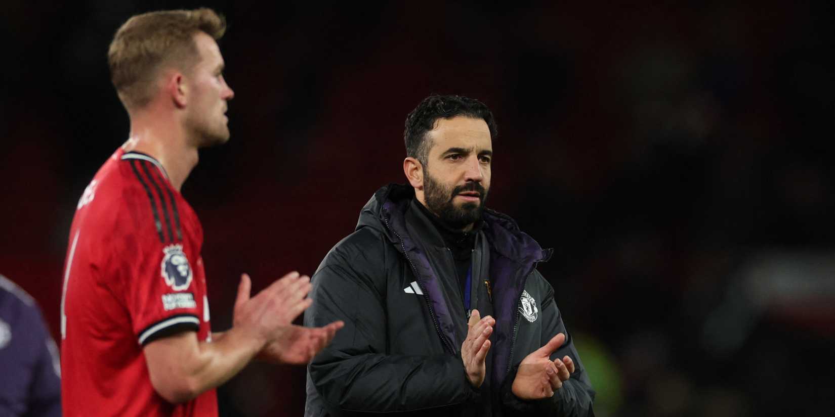 Manchester United manager Ruben Amorim applauds fans.