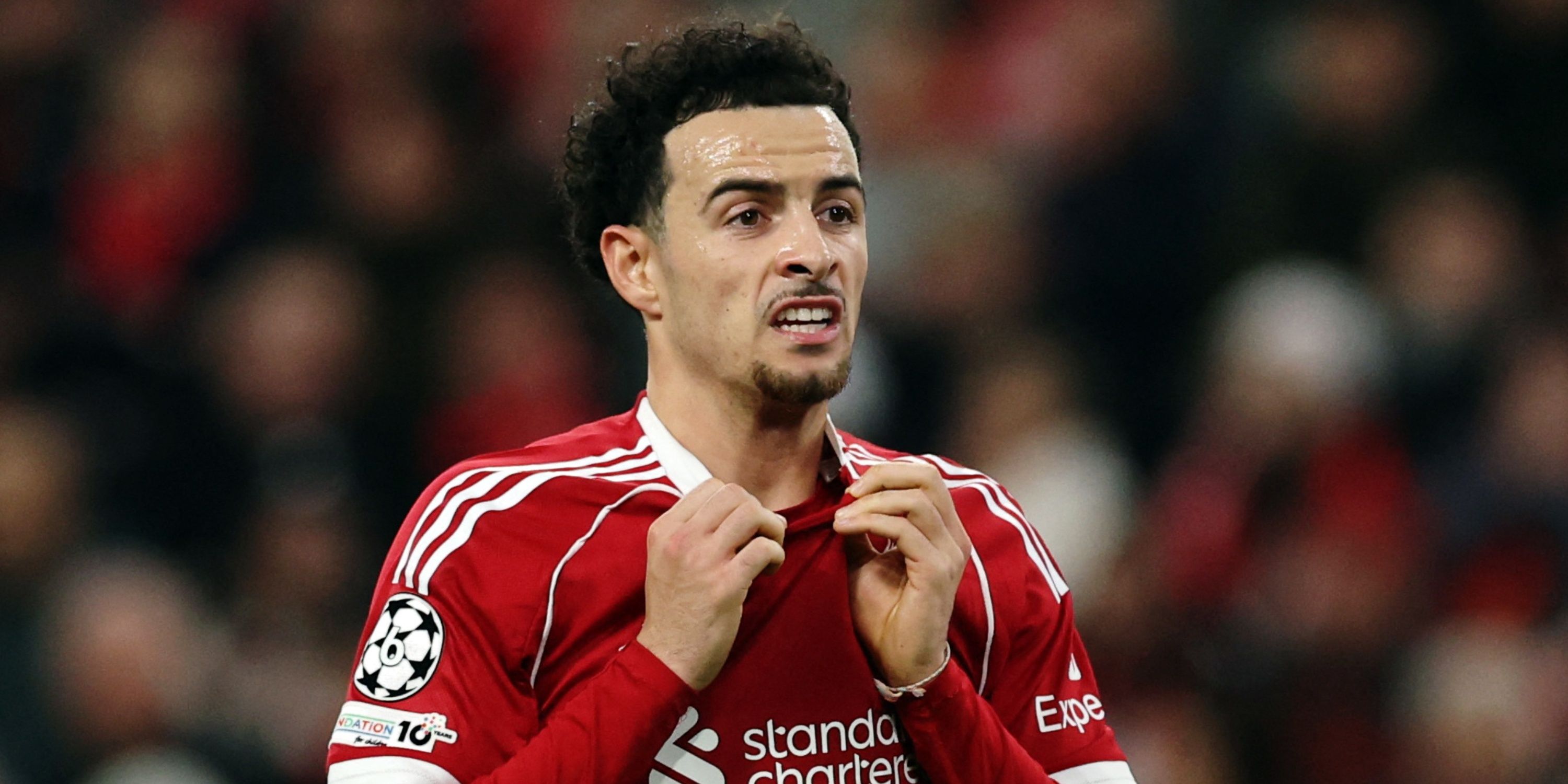 Liverpool's Curtis Jones pulls his shirt.