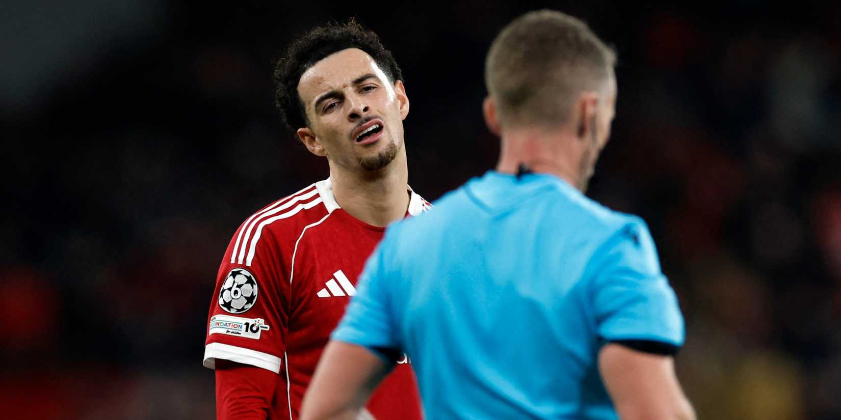 Liverpool's Curtis Jones reacts to the referee.