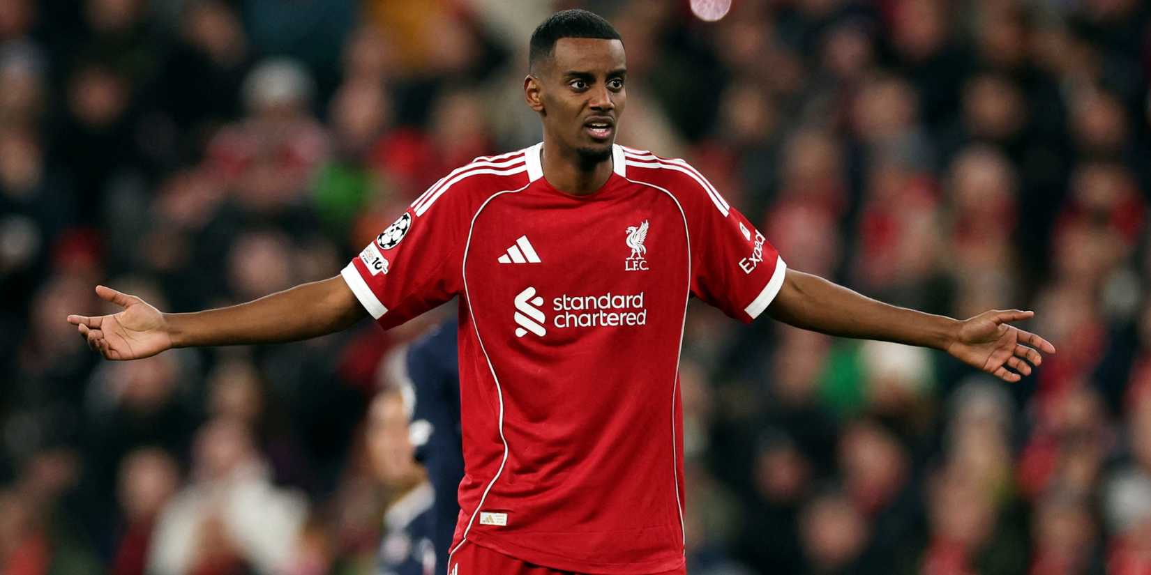 Liverpool's Alexander Isak raises his arms.