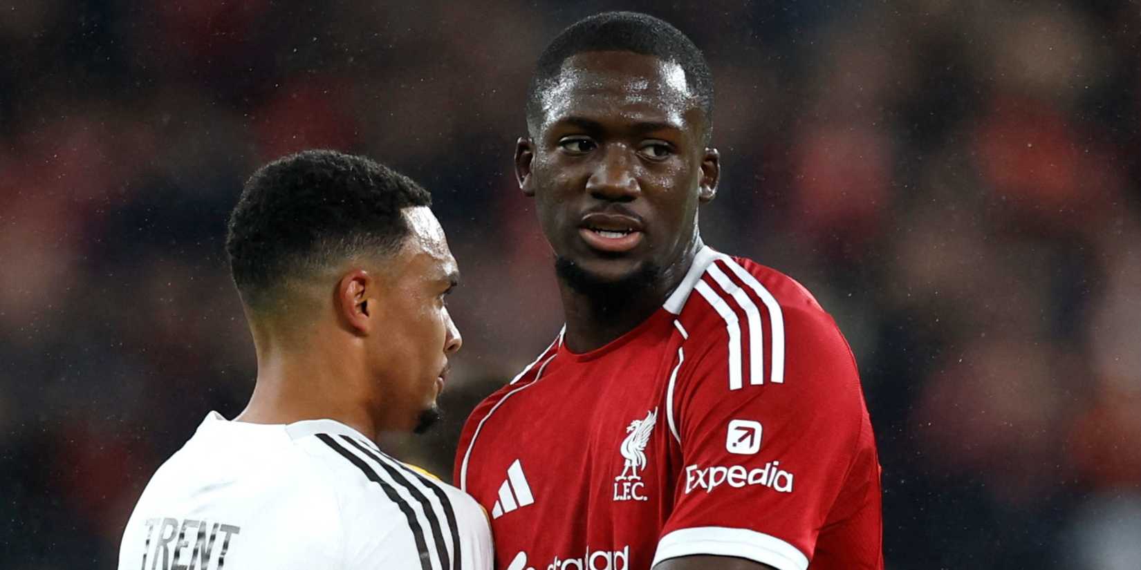 Liverpool's Ibrahima Konate hugs Real Madrid's Trent Alexander-Arnold