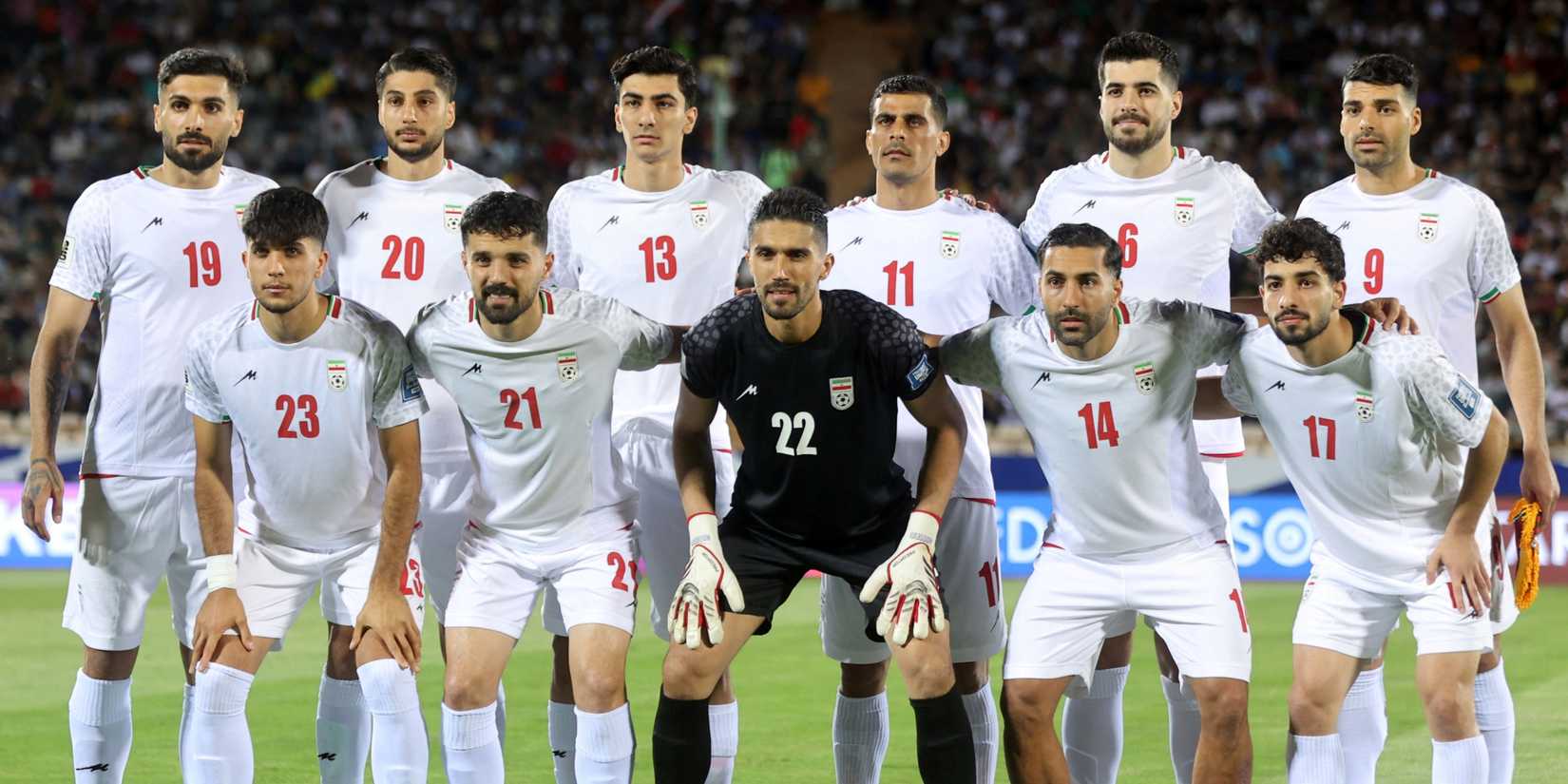 Iran players pose for team photo before their match against North Korea.