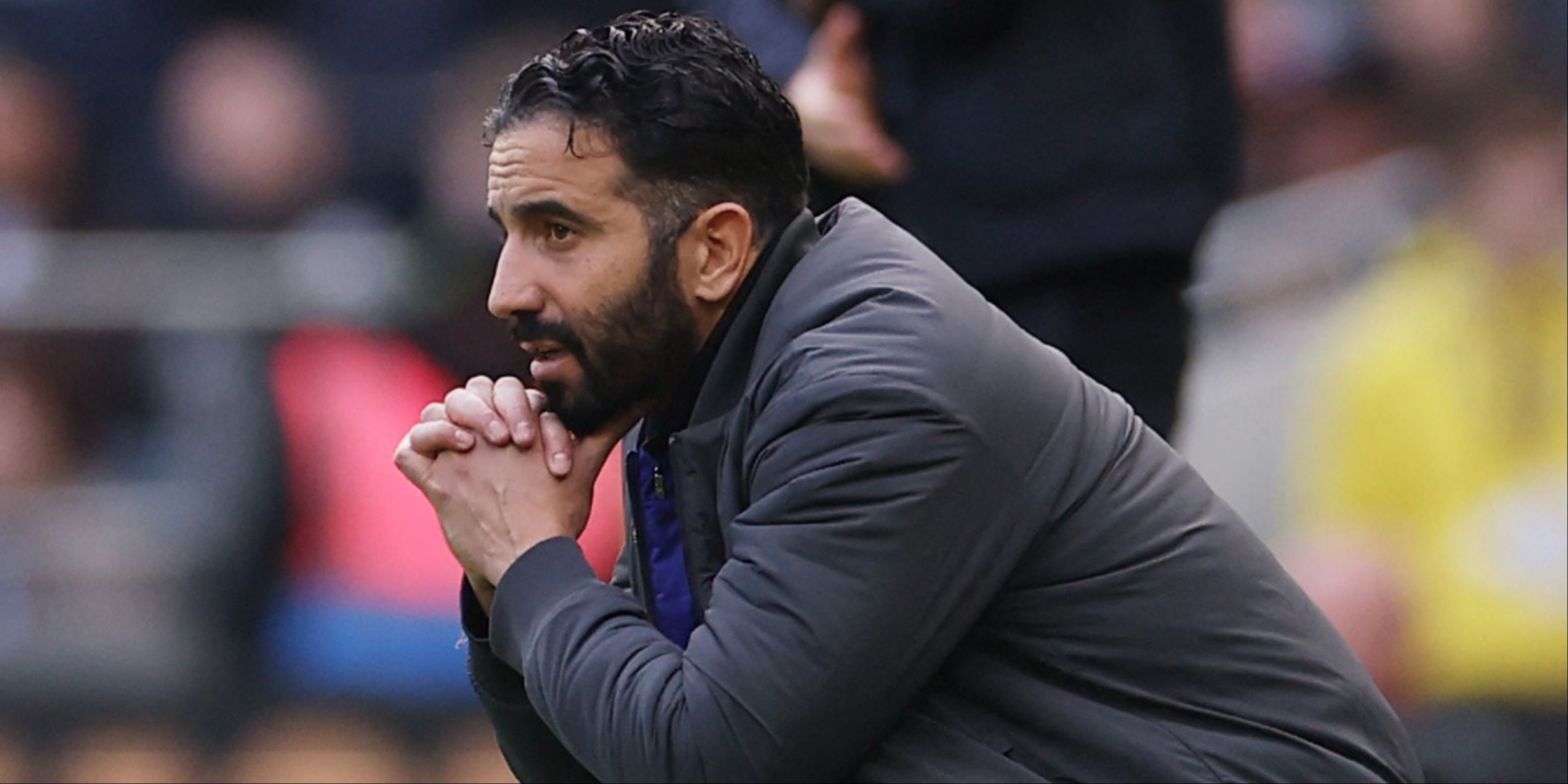 Manchester United manager Ruben Amorim crouches.