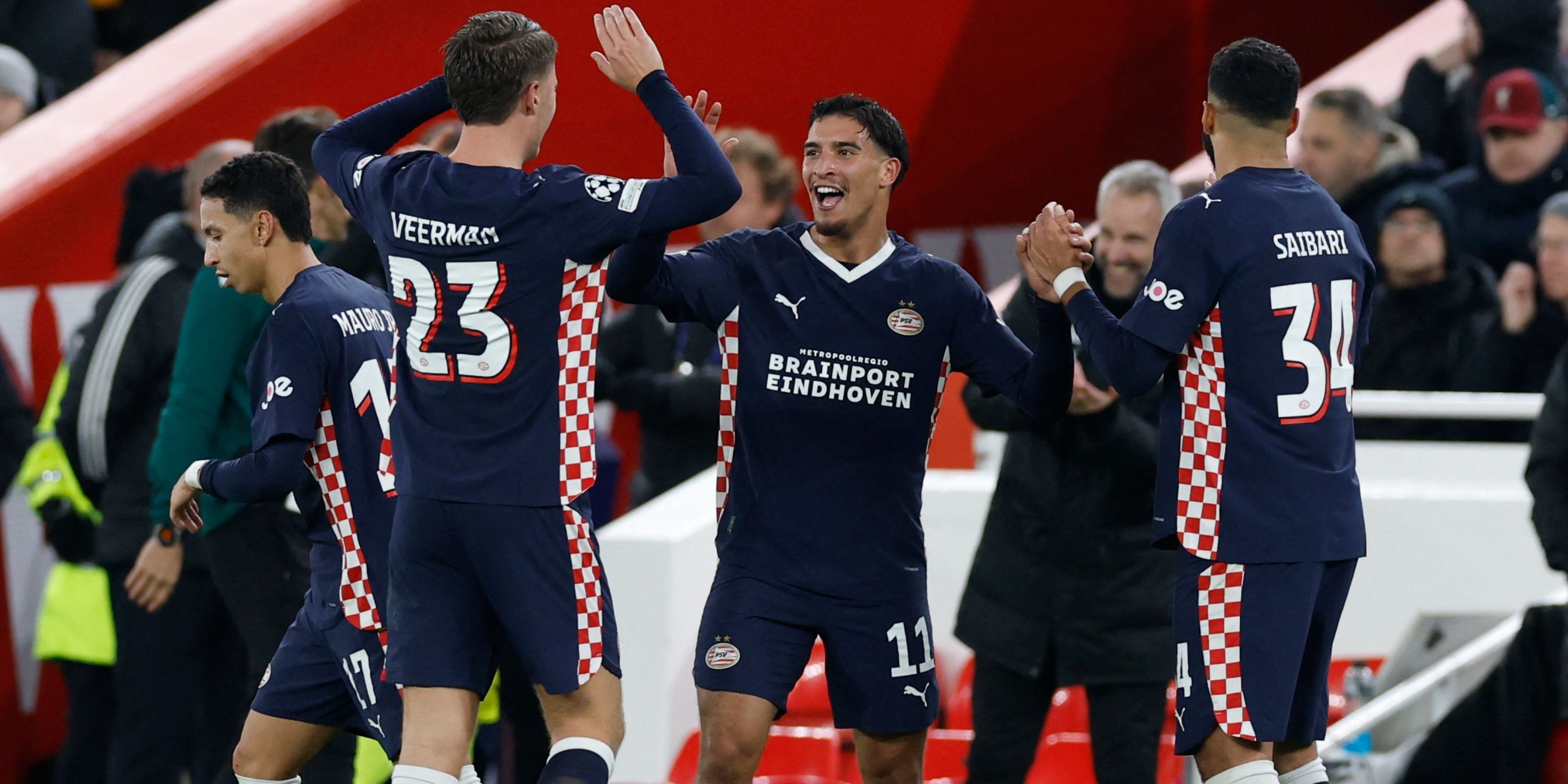 PSV players celebrating after defeating Liverpool in the UEFA Champions League