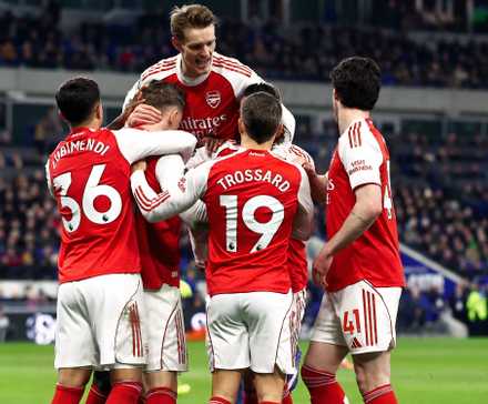 Arsenal players celebrating after scoring against Everton in the Premier League