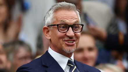 Former footballer and TV presenter Gary Lineker looking happy at Wimbledon in the royal box on centre court