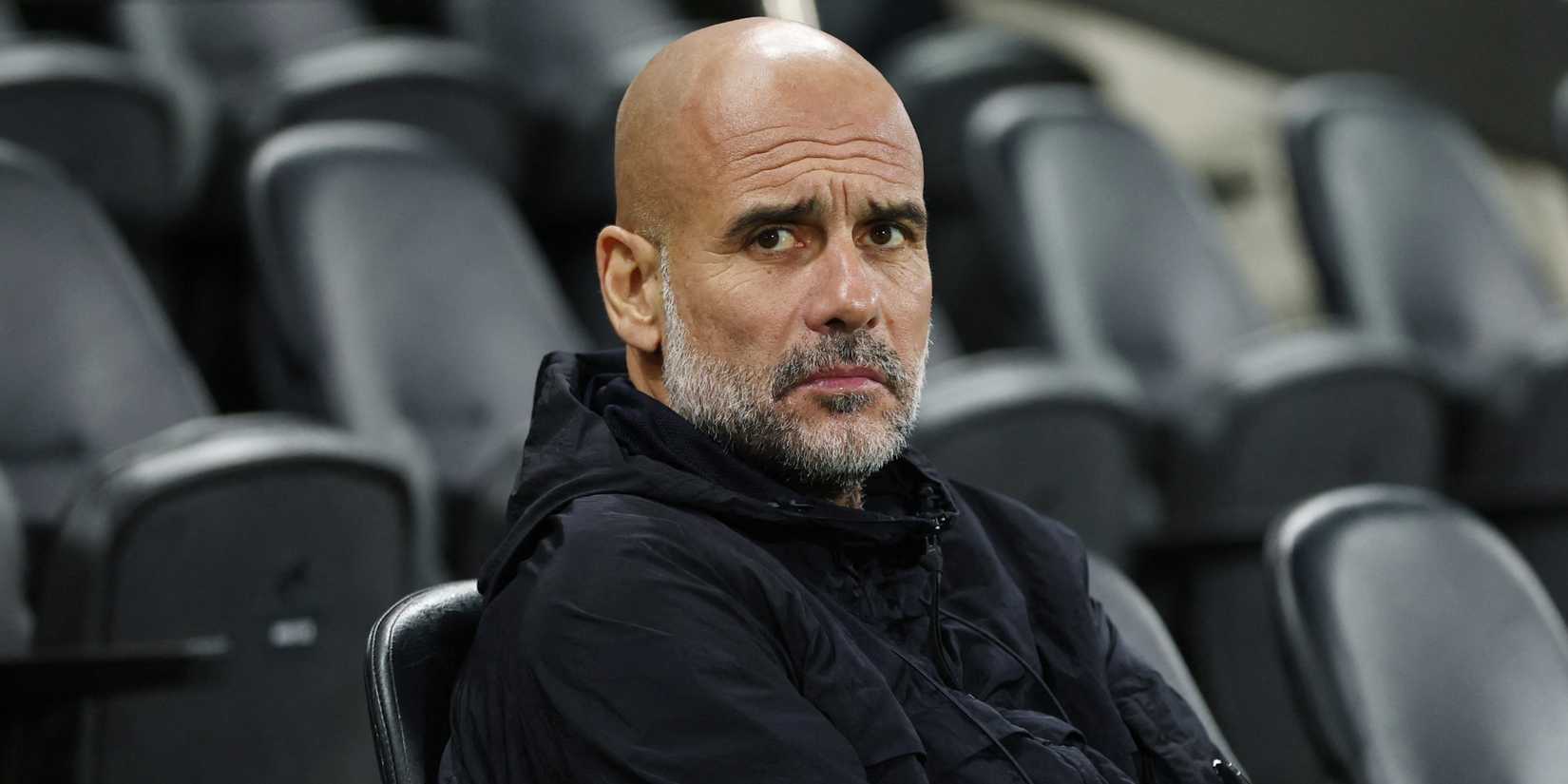 Manchester City manager Pep Guardiola sitting at Craven Cottage.