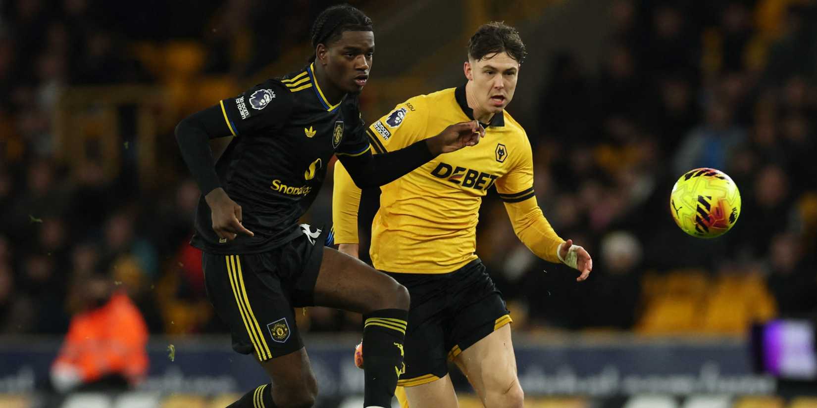Manchester United's Ayden Heaven in action with Wolverhampton Wanderers' Jorgen Strand