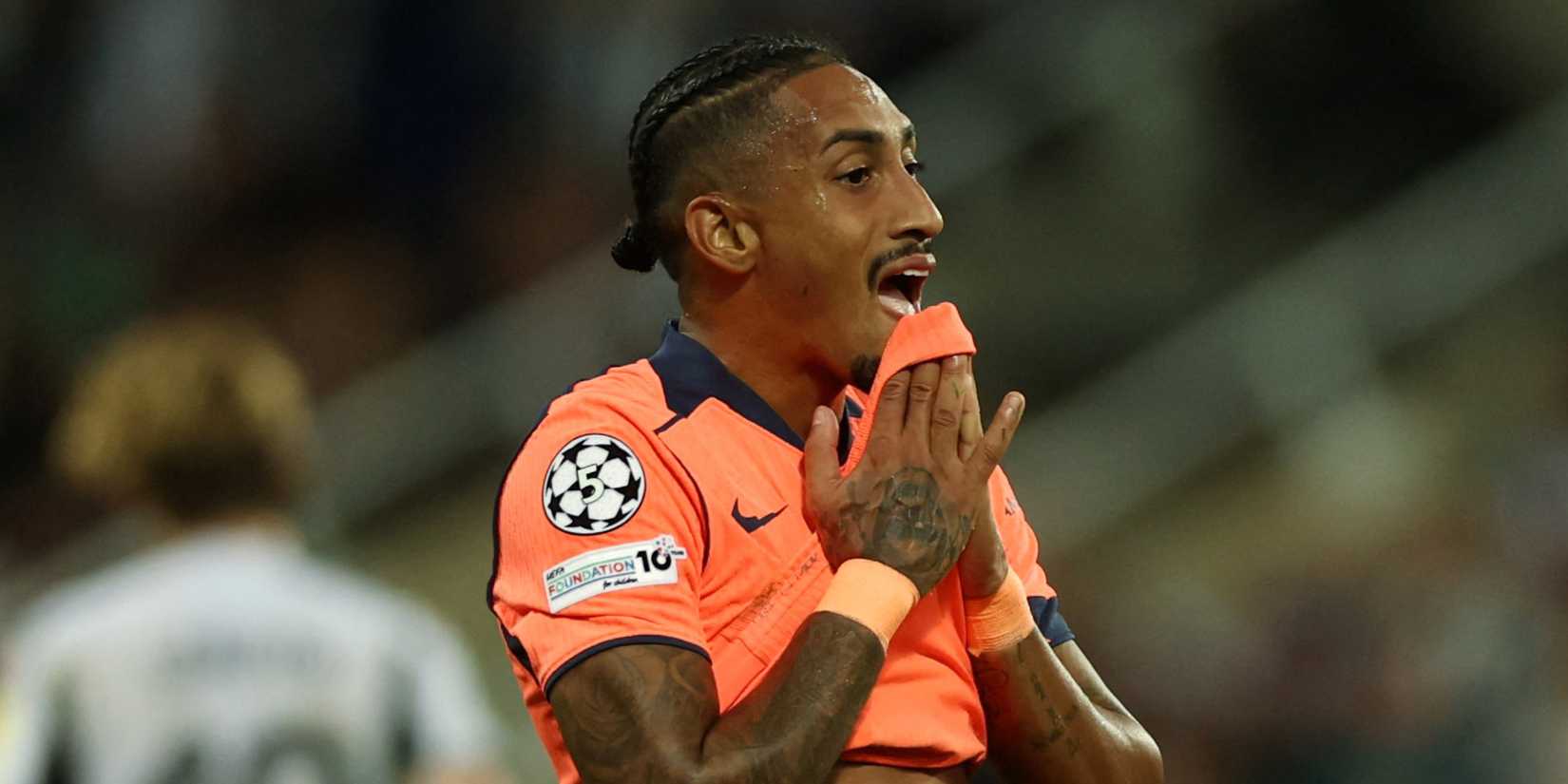 Barcelona's Raphinha holds his hands to his face.