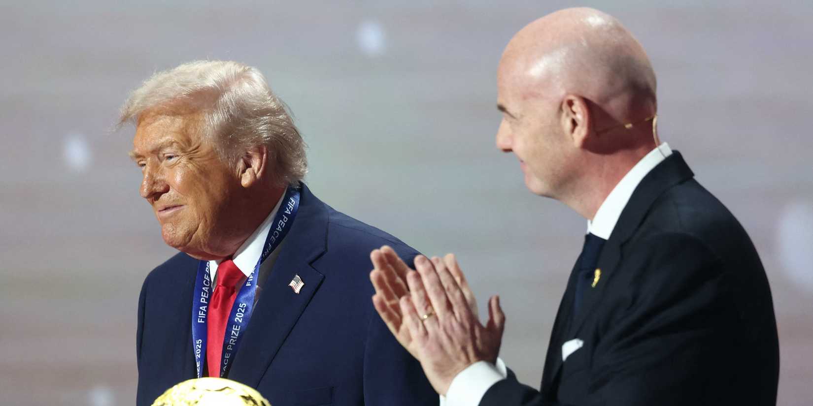 U.S. President Donald Trump is applauded by FIFA President Gianni Infantino