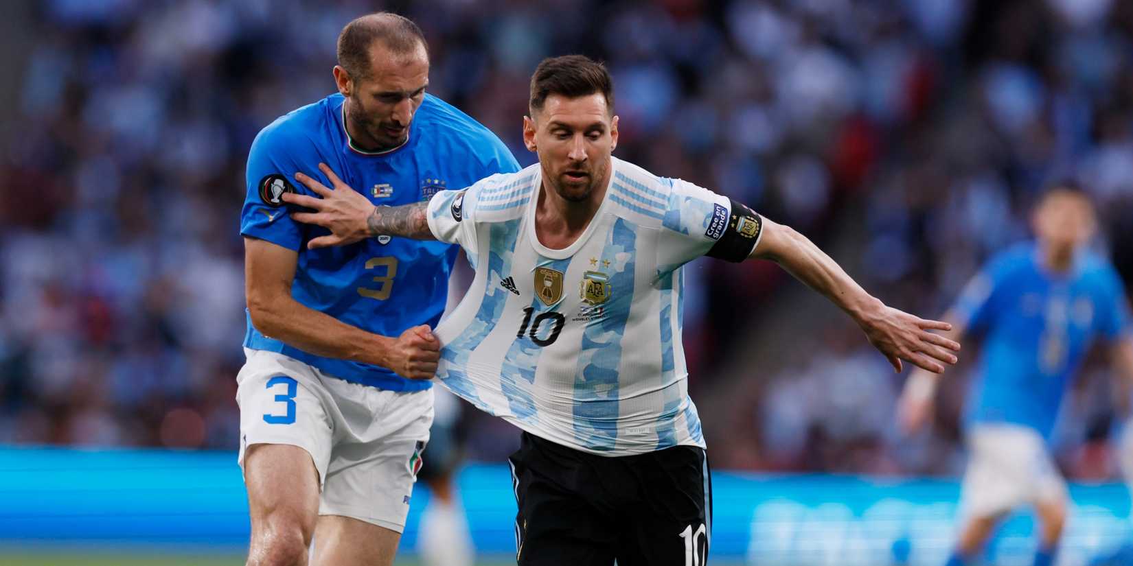 Argentina's Lionel Messi in action with Italy's Giorgio Chiellini