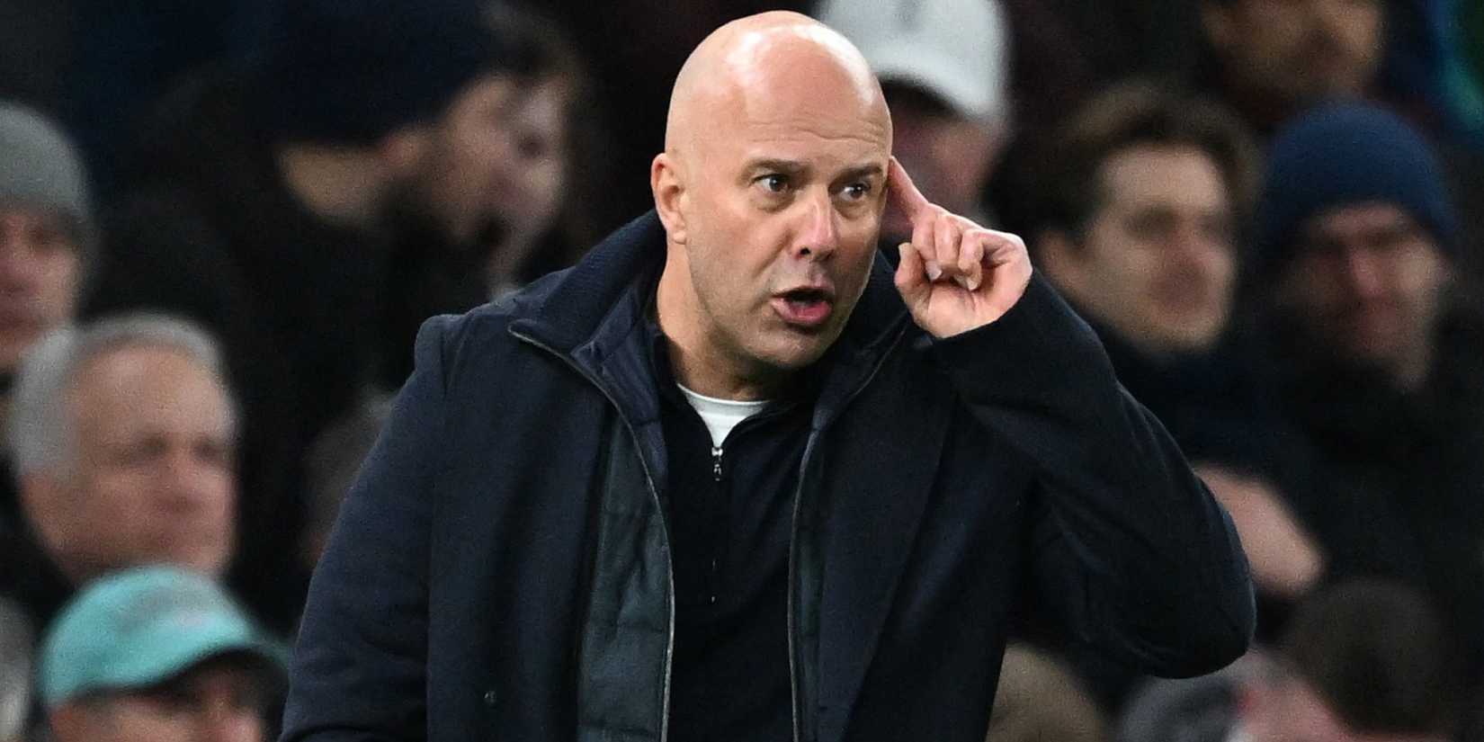 Liverpool manager Arne Slot puts a finger to his head.