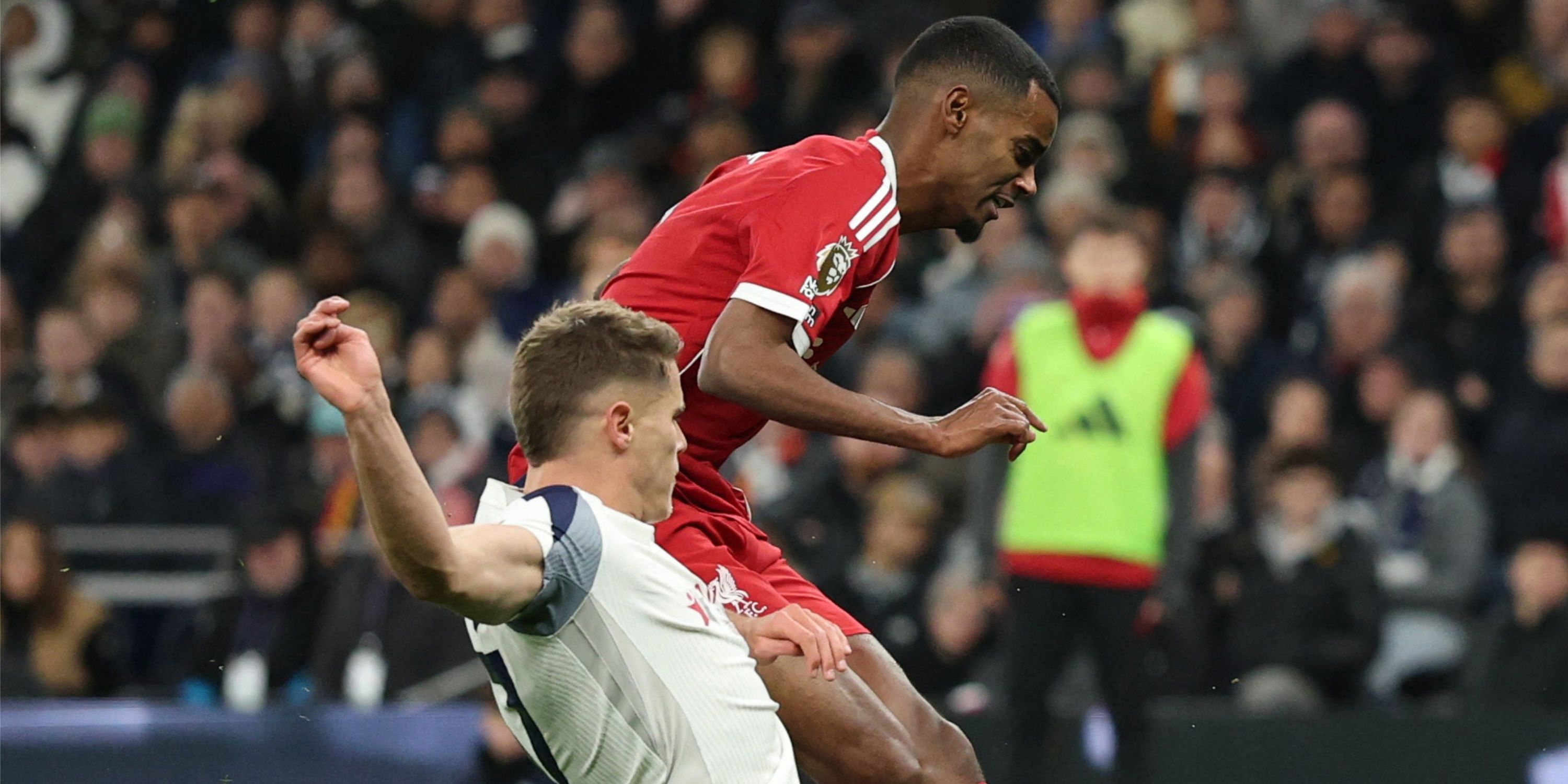 Liverpool's Alexander Isak scores despite a sliding tackle from Tottenham's Micky Van de Ven.